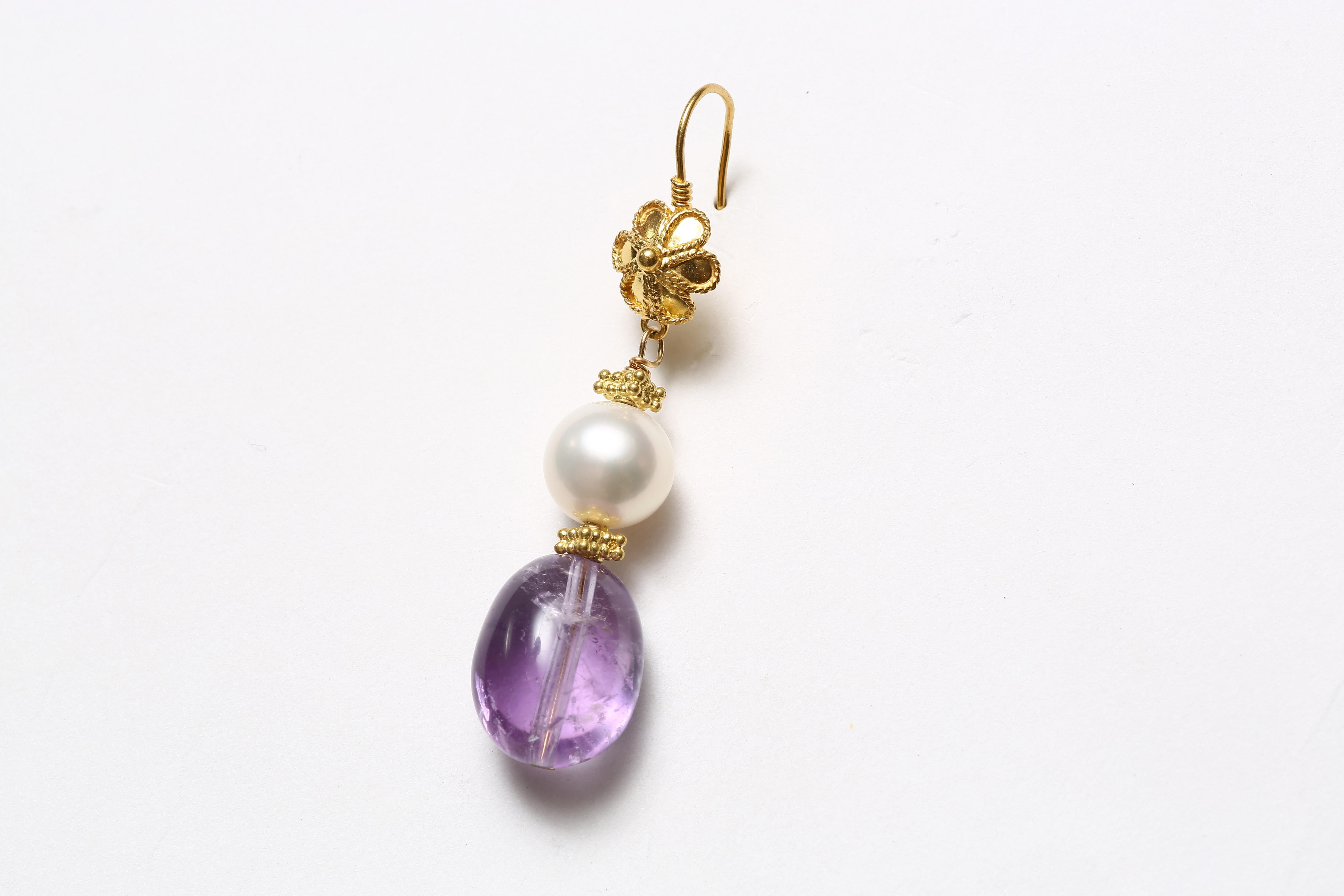 The charming pair of earrings with hand-worked 18K solid gold floral hooks, fresh water pearls and  amethyst drops. 
