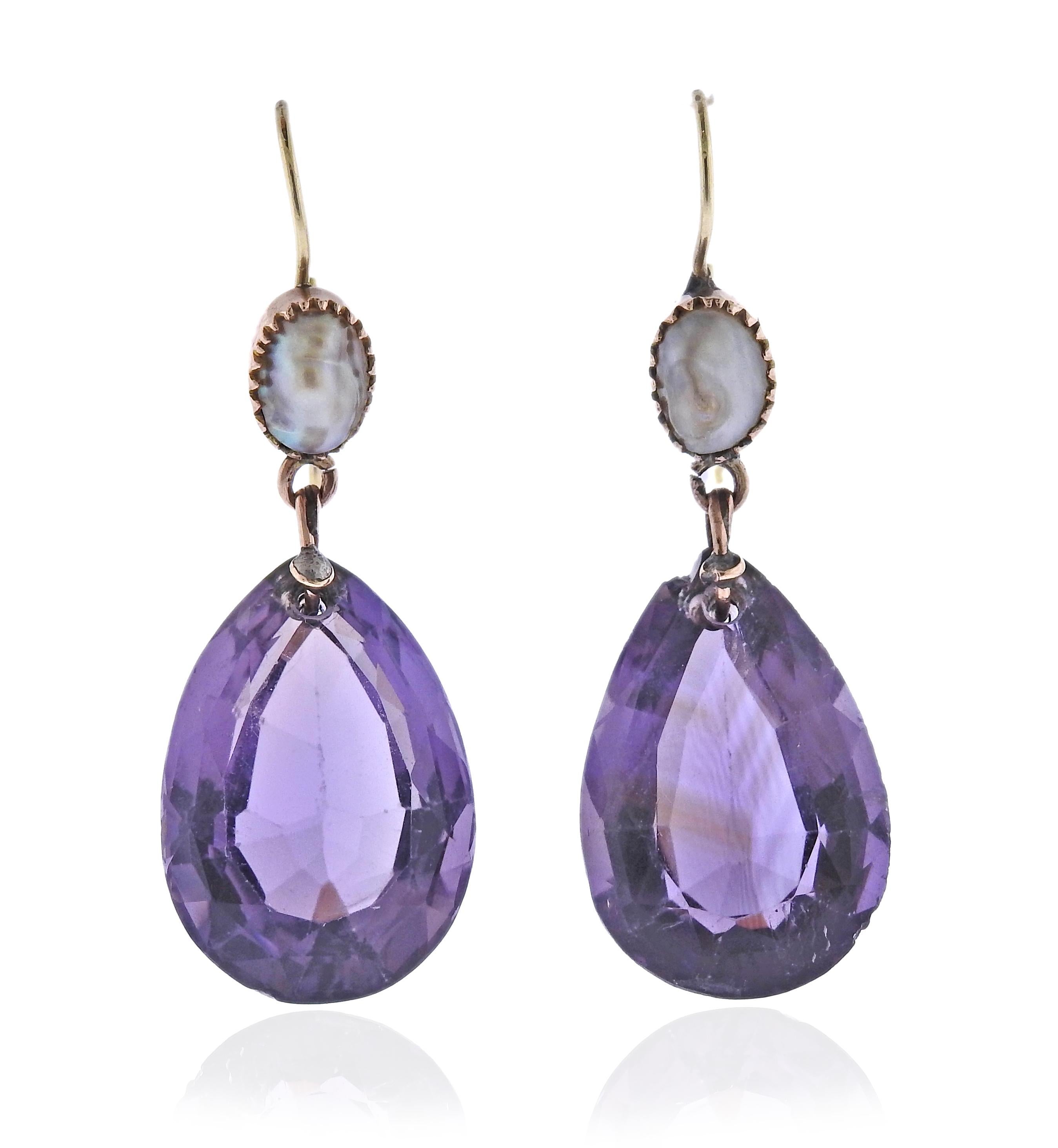 Pair of 14k gold drop earrings, with amethysts (stones are chipped) and pearls. Earrings are 39mm long. Weigh 6.4 grams.