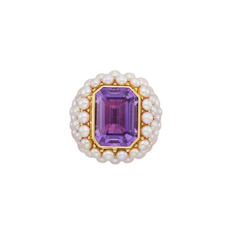 A Gold, Amethyst and Freshwater Pearl Ring by Mimi.
18 kt., centering one emerald-cut amethyst approximately 20.0 x 15.2 mm., within a bubbling mount of freshwater pearls, signed Mimi, approximately 28.4 dwts. gross. Size 7 1/4 (size is adjustable)