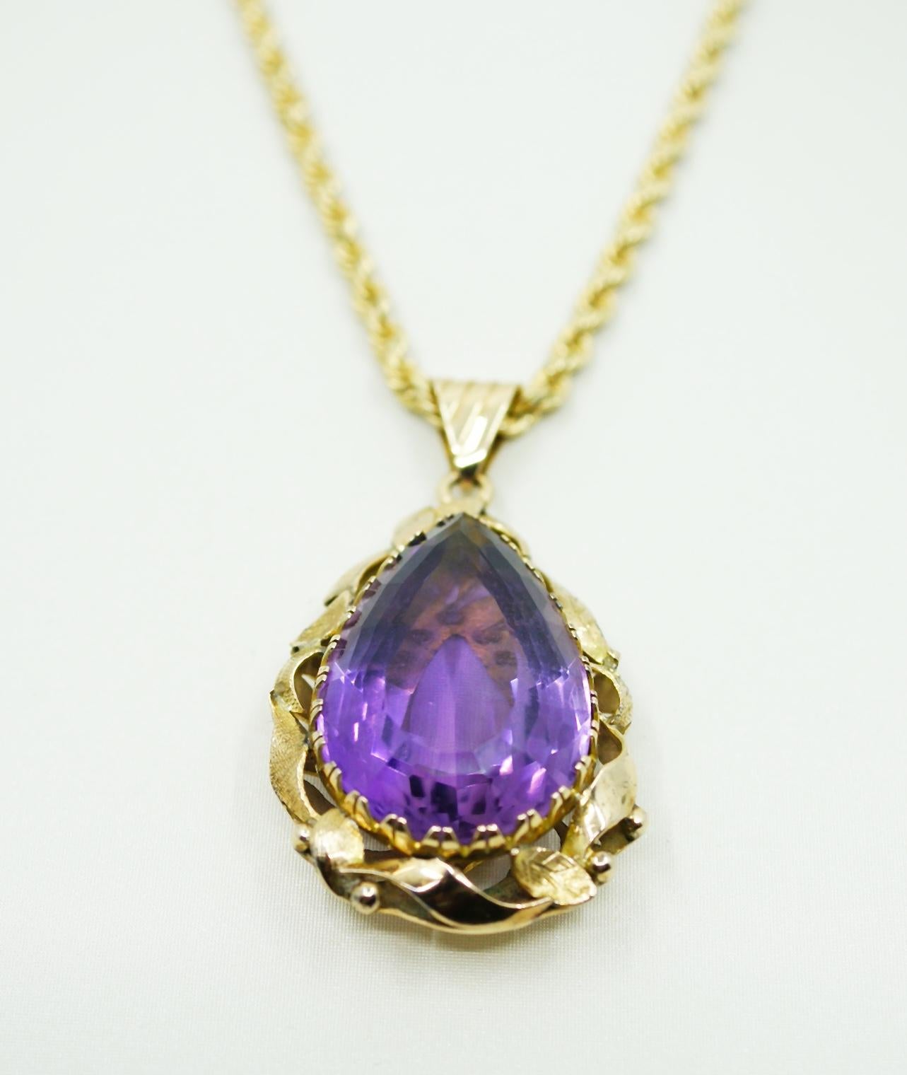 An exquisite 65 Carat Pear Shape Vibrant Amethyst set in a 14K Yellow Gold Pendent

• Amethyst Weight: 65 Carats
• 14K Yellow Gold 
• Signed: JC
• Pendent Measures: 2 inches long (5.5cm) 1.5 inches wide (3cm)
• Grams: 19.3 / 12.41 DWT / *Chain not