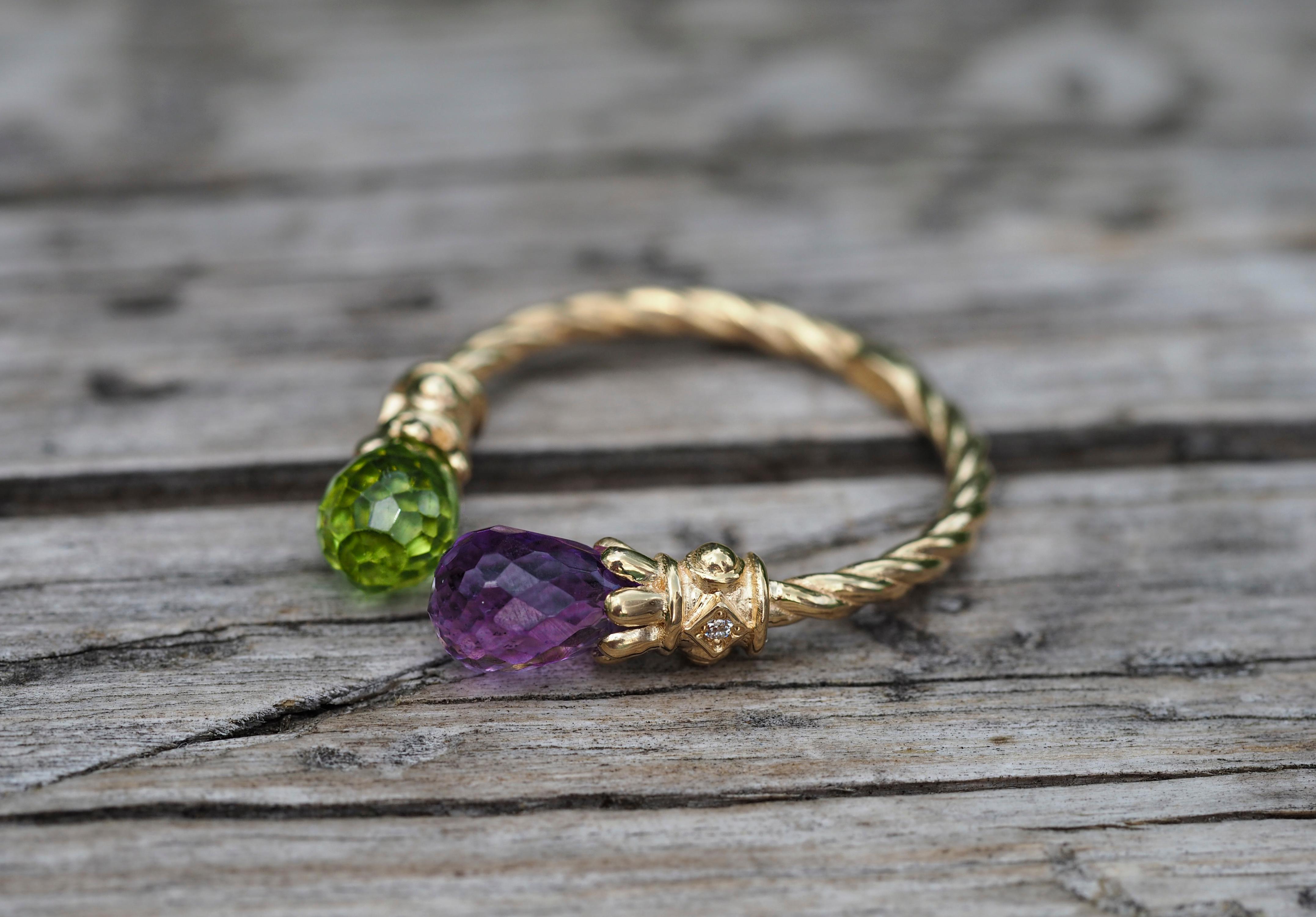 Amethyst, Peridot 14k gold ring. 
Briolette amethyst, peridot gold ring. Open enged, adjustable ring. Twisted gold ring. Two gemstone ring.

Total weight: 2.60 g. depends from size.
Metal: 14k gold

Stones:
Peridot:
Cut: Briolette
Weight: approx 1.0