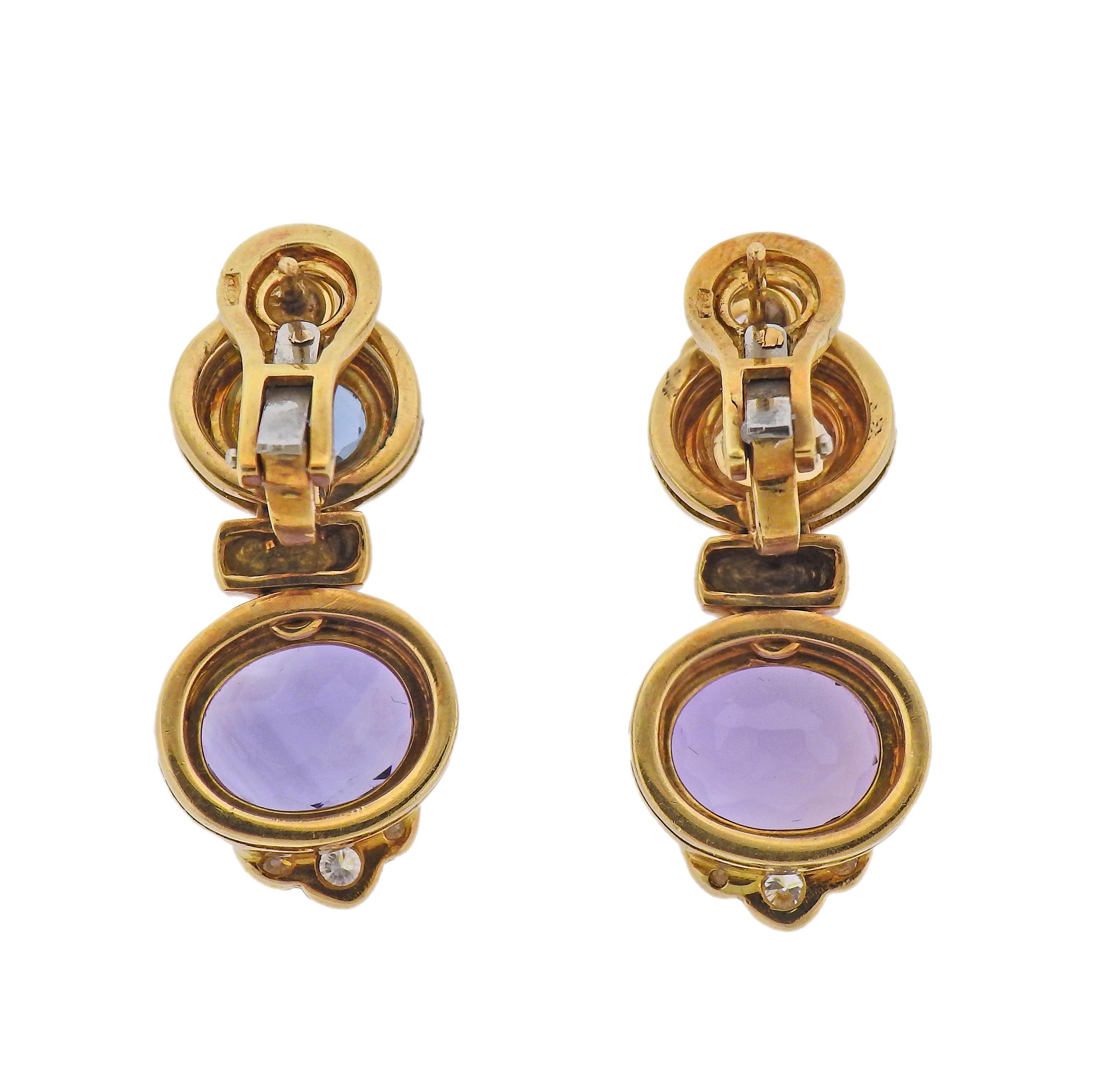 Pair of 14k gold earrings with amethyst and peridot. Earrings are 25mm x 20mm. Marked 14k. Weight - 23.2 grams.