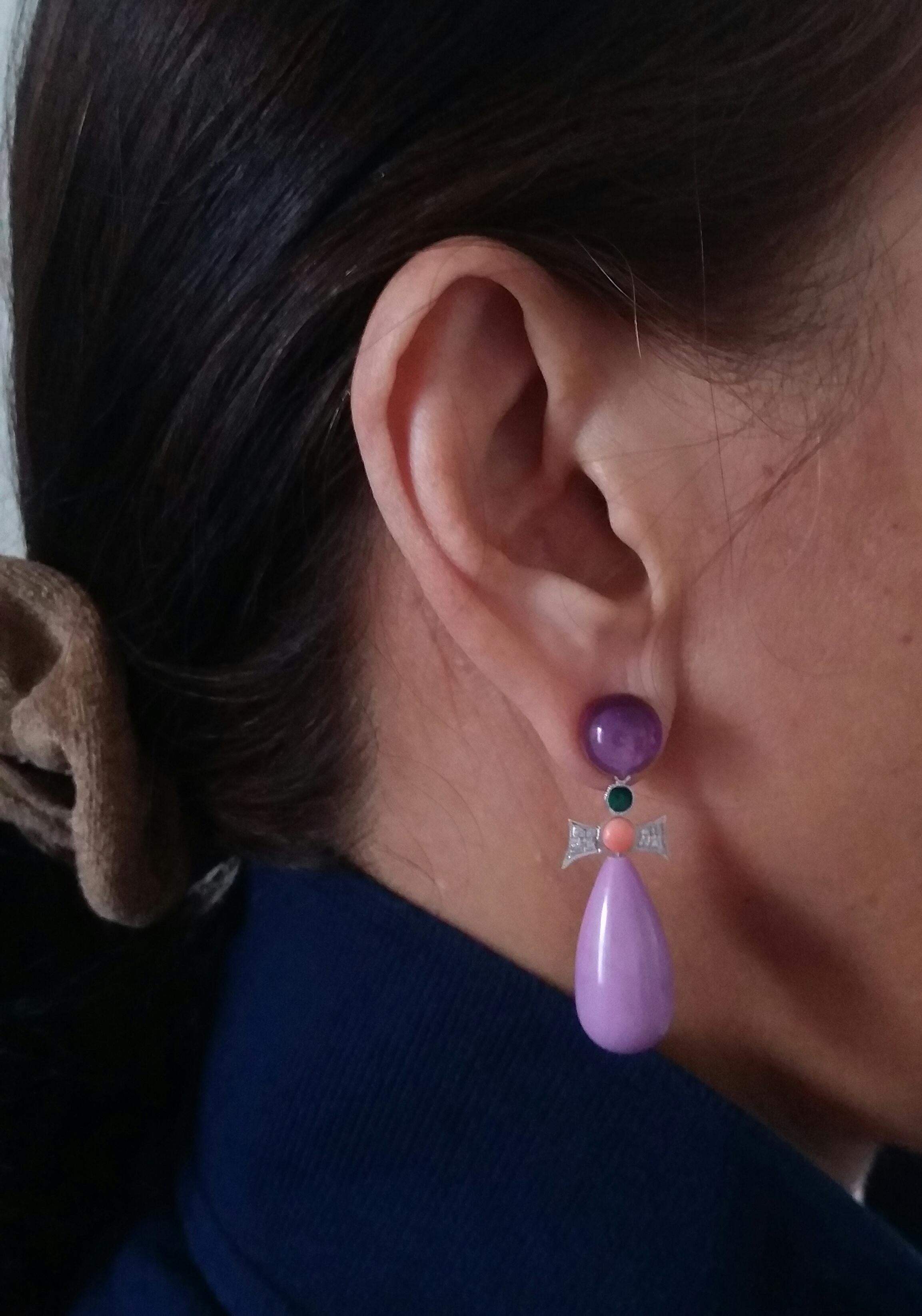 In this pair of earrings 2 round buttons of amethyst diameter 10mm. support 2 elements in white gold diamonds small coral round cabochons and green enamel, the bottom is composed of 2  phosphosiderite round drops size 24 x 12 mm.
In 1978 our