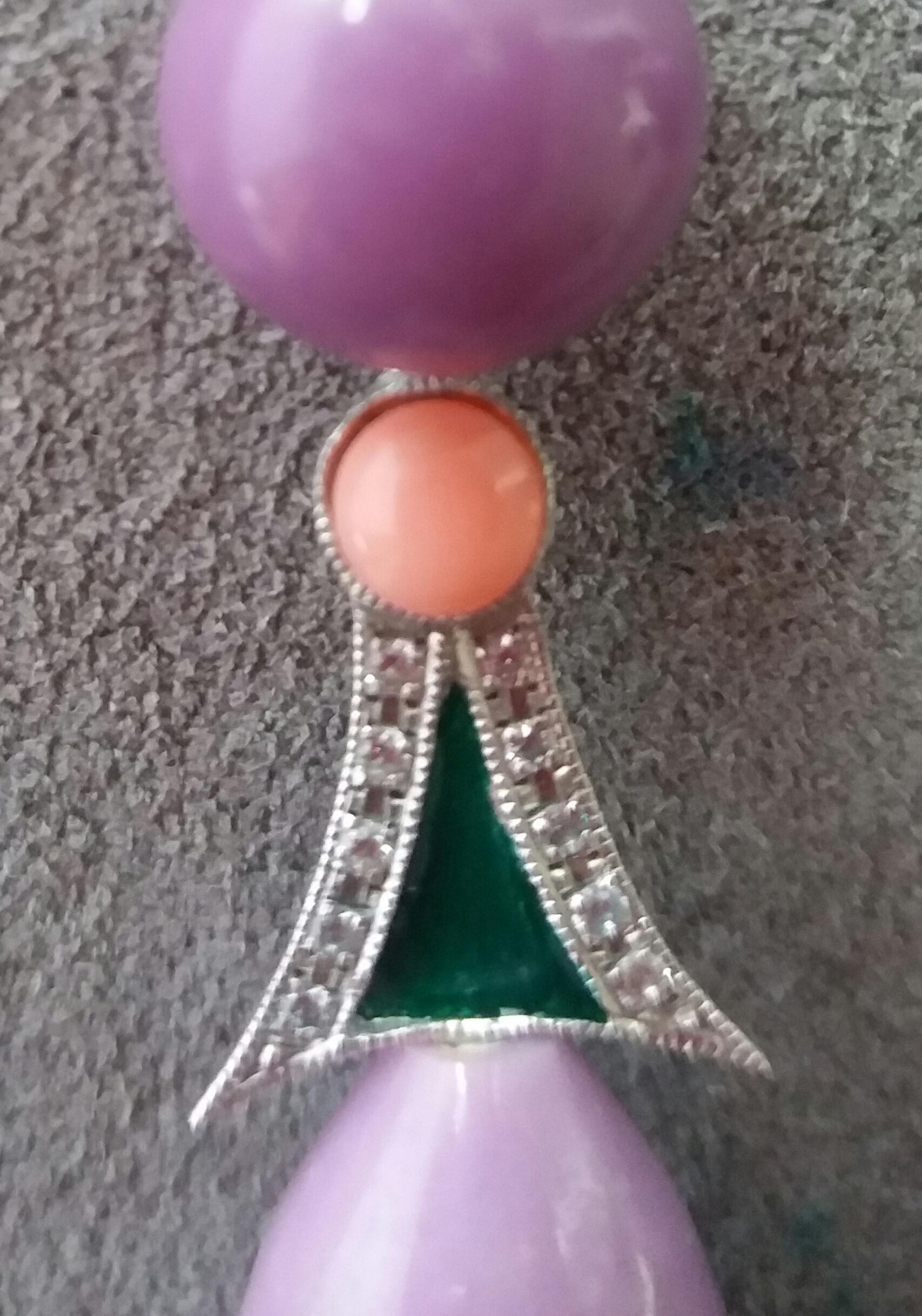 These earrings have the upper part consisting of 2 round Phosphosiderite buttons diameter 10mm.They support 2 white gold elements, diamonds, green enamel and 2 small pink Coral buttons, in the lower part we have 2 Phosphosiderite round drops