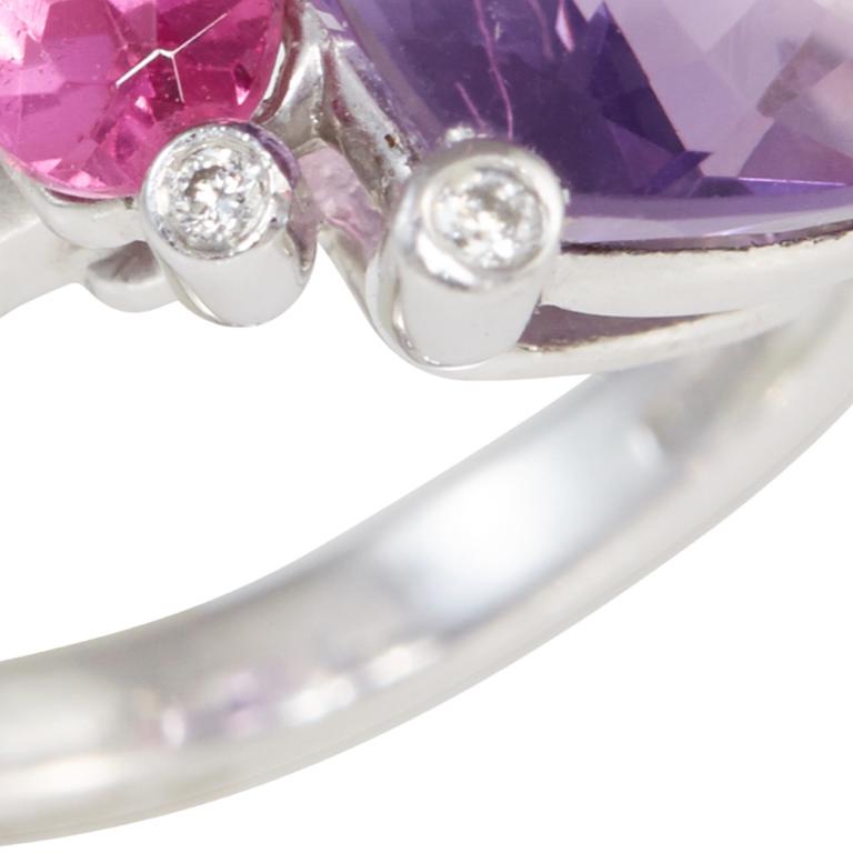 Beautiful cushion amethyst ring with pink topaz shoulders. Each point of the claws has a diamond. In 18 carat white gold. Ring available in size M.  Please note this item is made to order and a similar but not identical piece can be made. Allow four