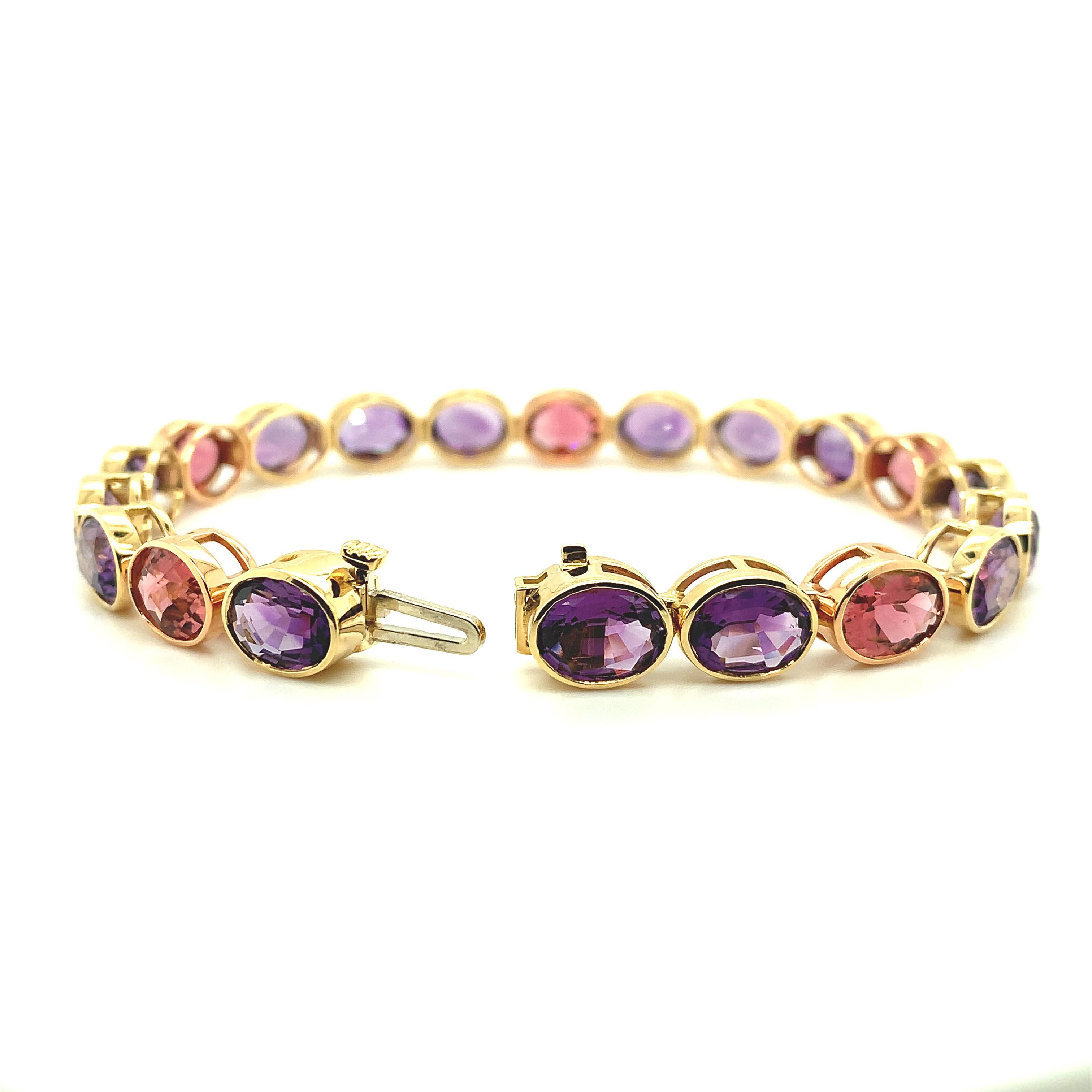 Bright, sparkling amethysts are paired with brilliant pink tourmalines in this beautifully handmade 18k rose and yellow gold bracelet! Each bezel set gem weighs over one and half carats apiece; large enough for them to be set as center stones in