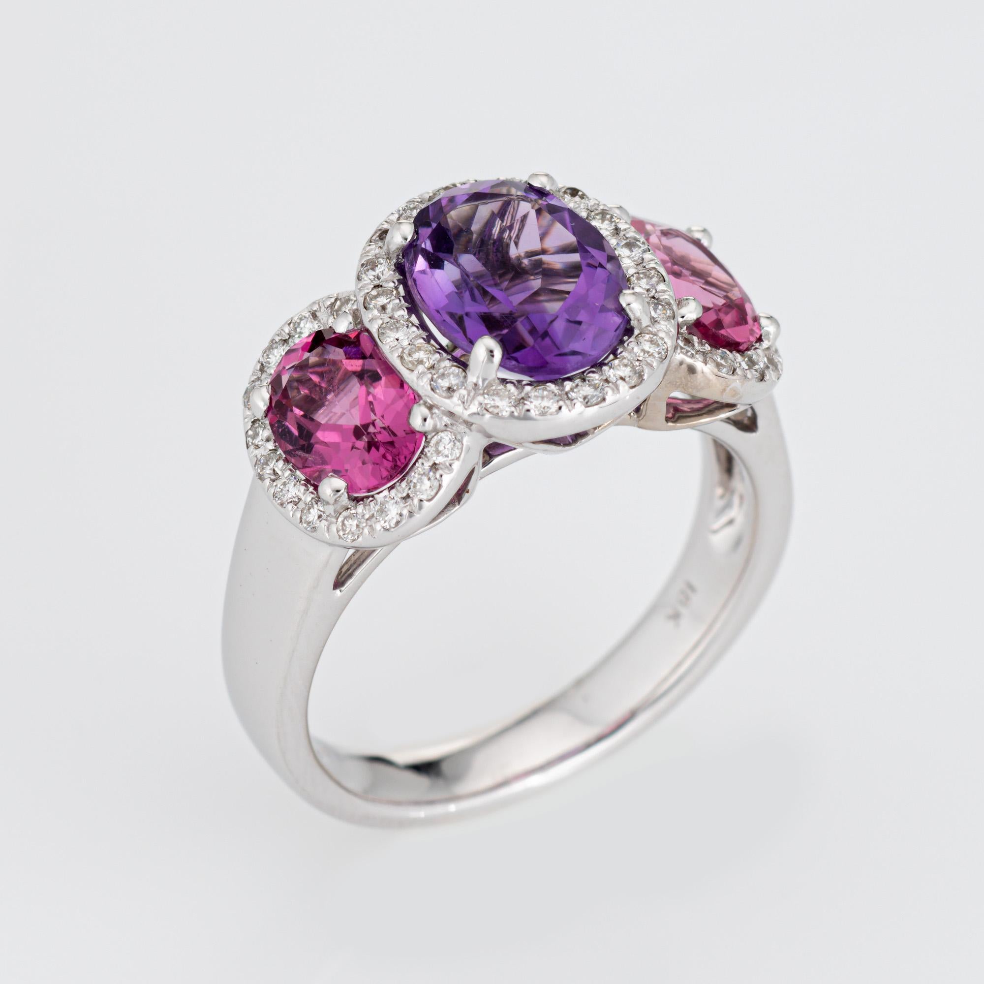 Stylish amethyst & pink tourmaline diamond trilogy ring crafted in 18 karat white gold. 

Oval faceted amethyst measures 9mm x 7mm (estimated at 2 carats), accented with two pink tourmalines measuring 7mm x 5mm (estimated at 1 carat each - 2 carats