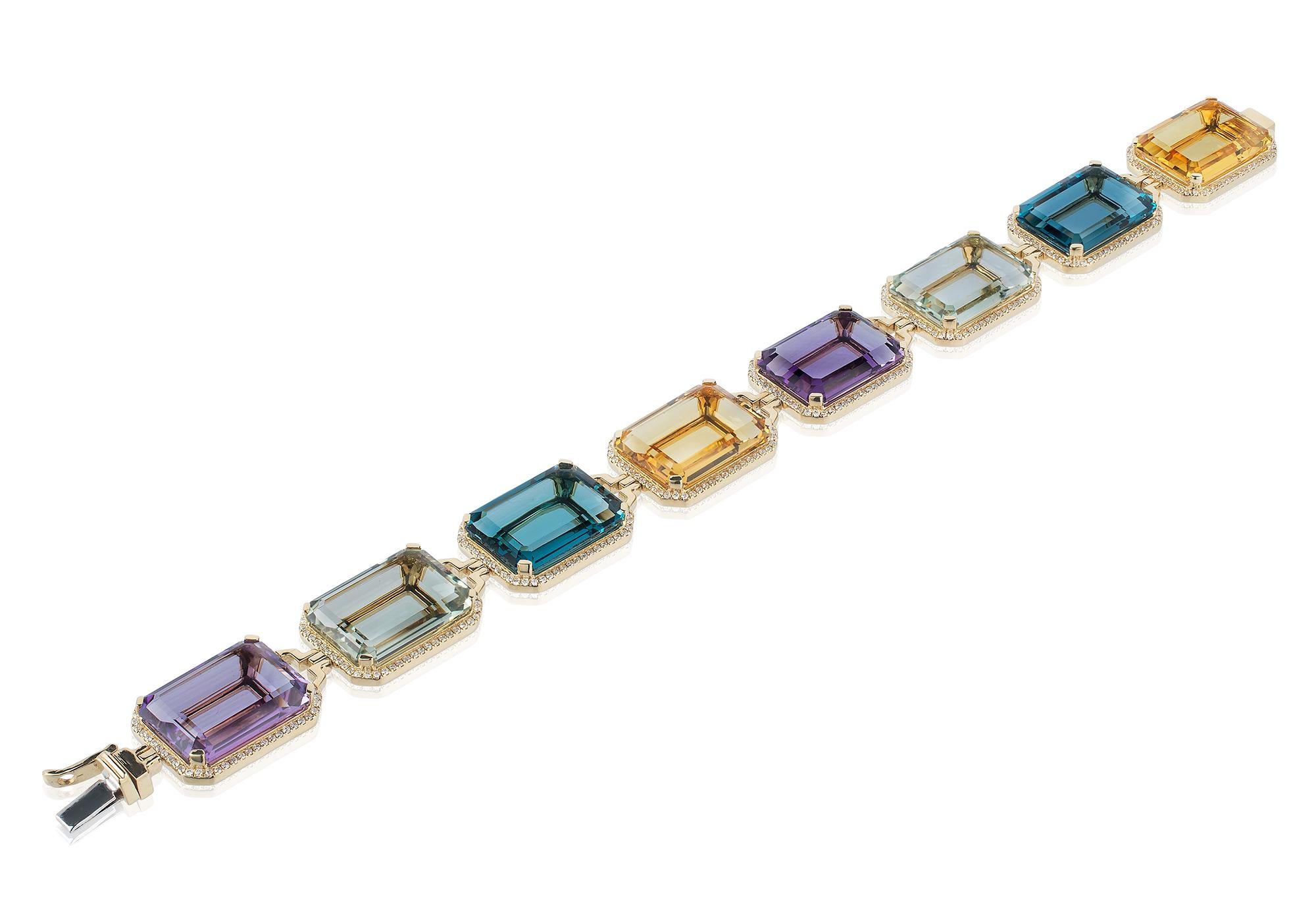 This Amethyst, Prasiolite, London Blue Topaz and Citrine Emerald Cut Bracelet in 18K Yellow Gold with Diamonds is a stunning piece of jewelry from the 'Gossip' Collection. The bracelet features a combination of four different gemstones, each with