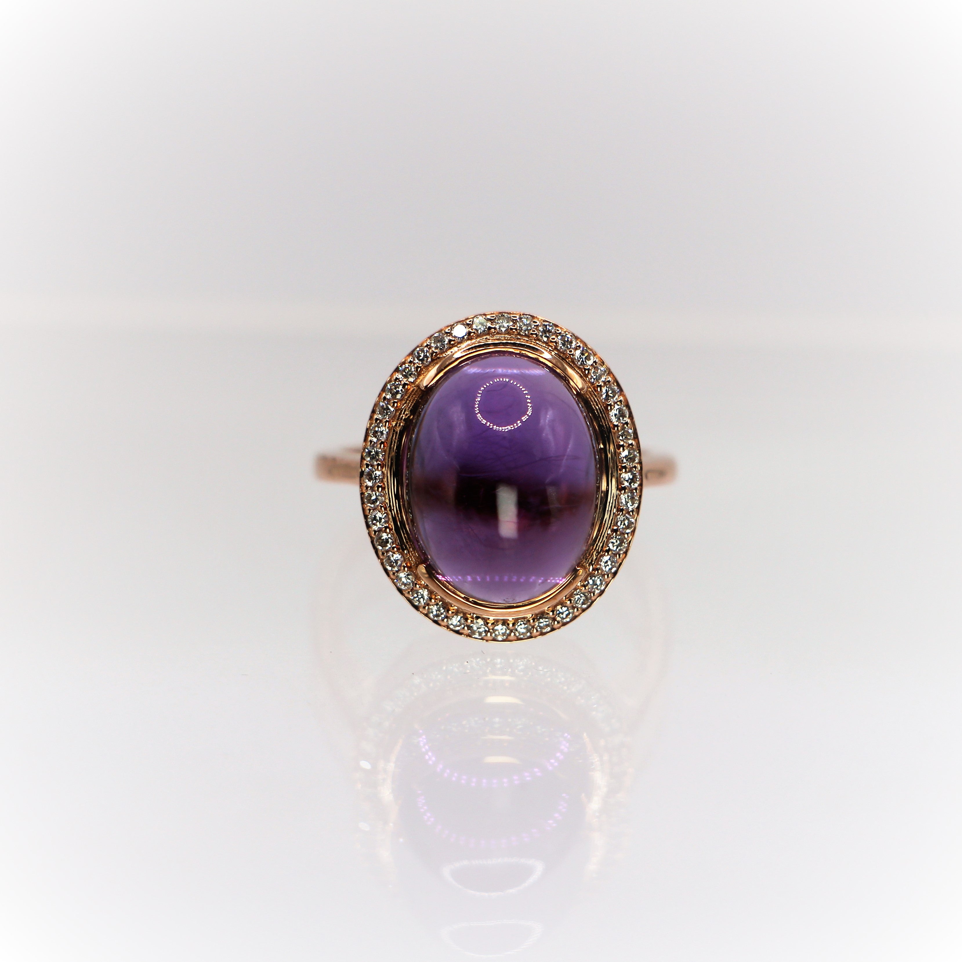 Amethyst Purple Oval Cabochon Cut Ring with pave Diamonds in 18 Carat Rose Gold 
The central stone is an Amethyst 8.53ct surrounded by brilliant cut pave diamonds 0.28ct
A delicate and stylish piece of jewelry,  a statement ring in vintage style