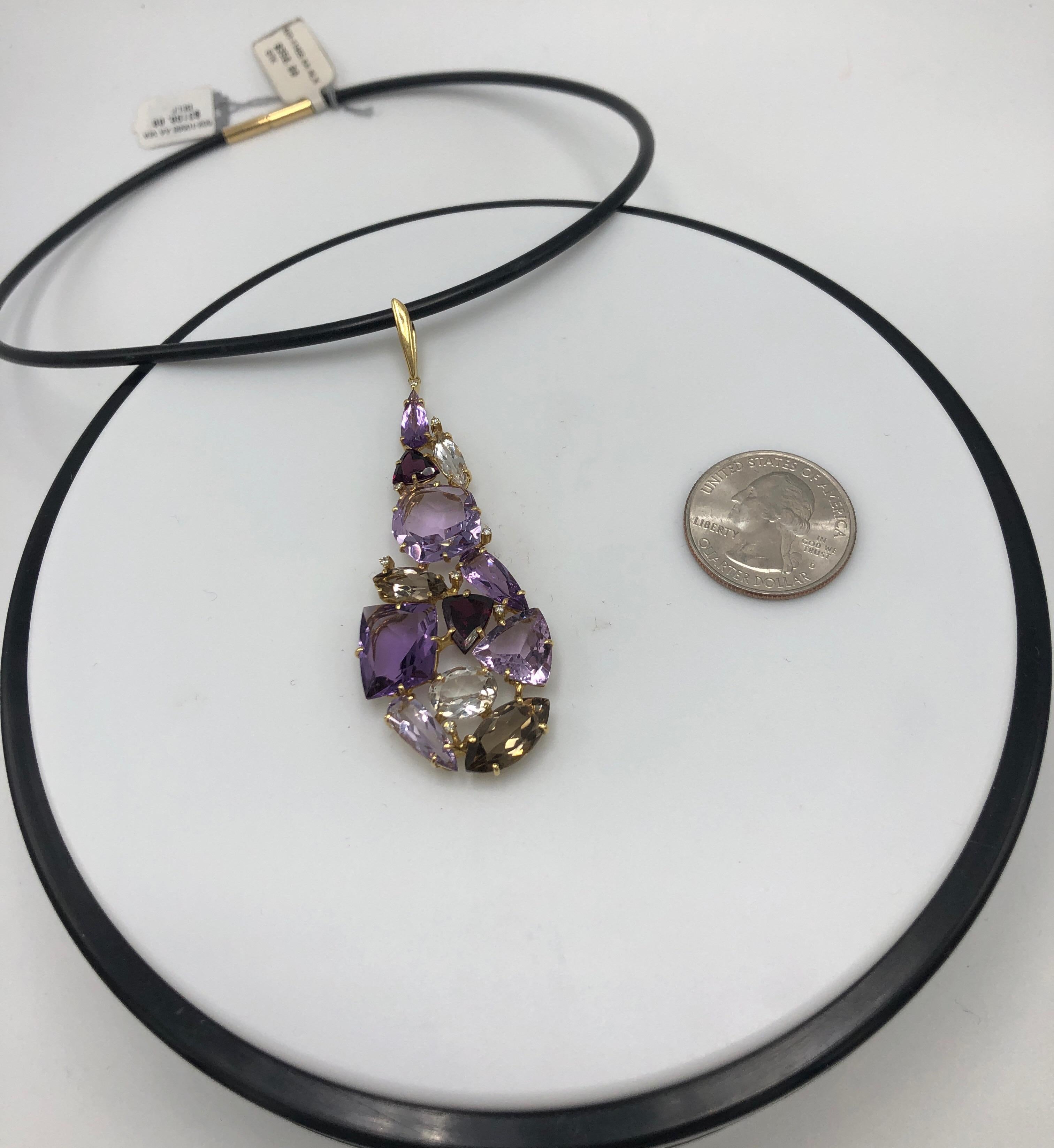 25.1 CTW Amethyst Quartz and Rhodolite in a mosaic teardrop pendant.  With .08CTW Diamond set in 18K Gold.  Hung on 18K Yellow Gold Clasped Leather Cord 16 inches in length.  Pendant made by Designer Vianna Brasil 