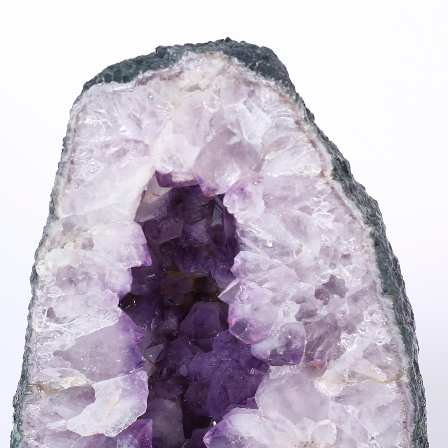 Enchanting geode specimen displaying Mother Nature's sculptural prowess with this fine example of Amethyst quartz crystals.
 