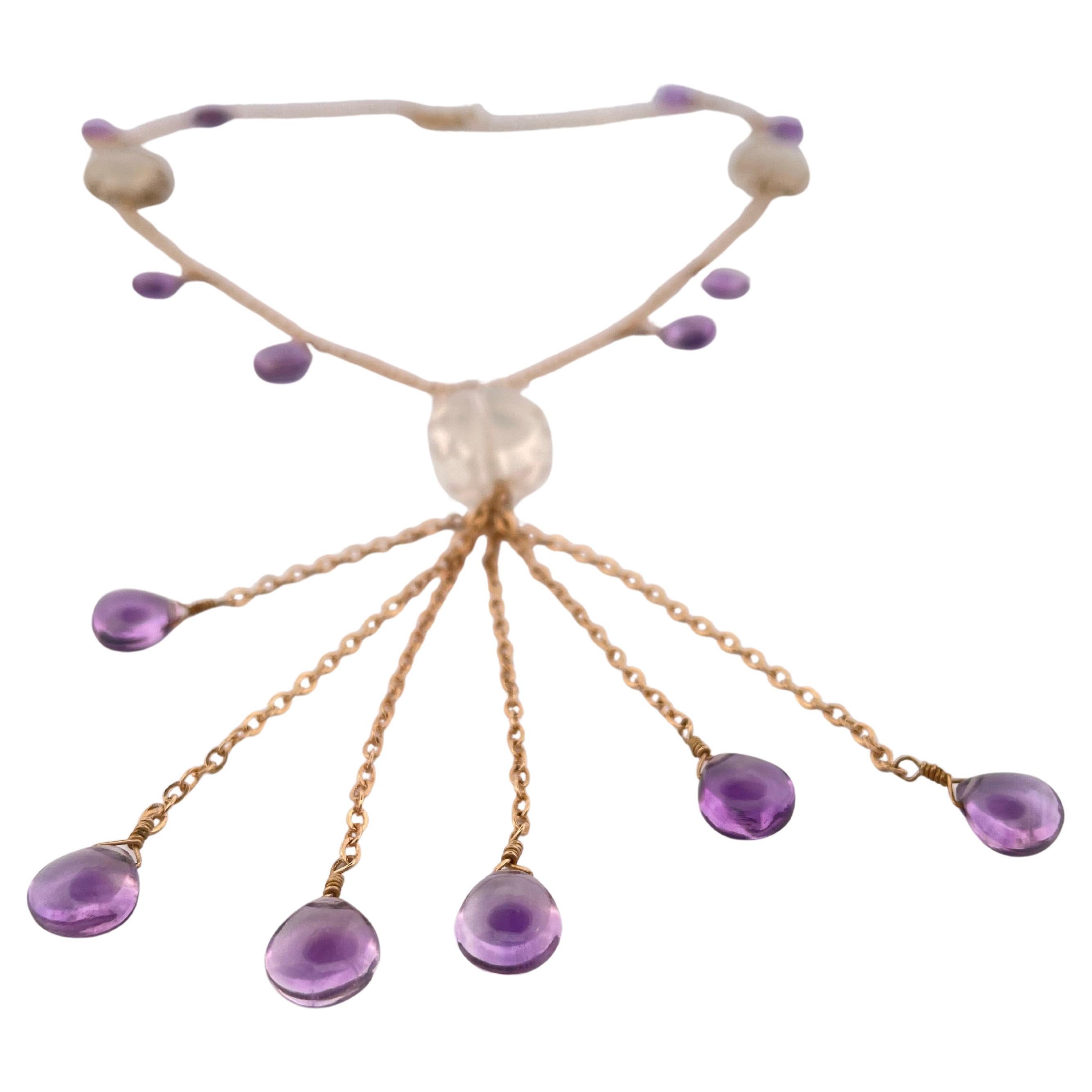 This exquisite 17-inch necklace showcases the harmonious pairing of rich amethyst and luminous quartz, artfully set in 14k yellow gold. Weighing 17.7 grams, the piece balances elegance with substance, offering both presence and wearability. Each