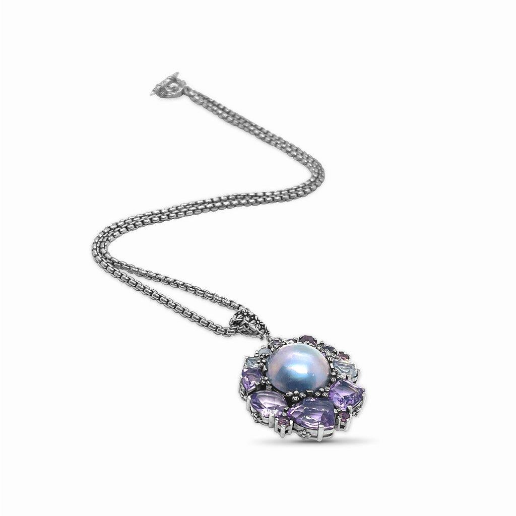 Indulge in the enchanting beauty of this Amethyst Rhodolite Garnet Pink Tourmaline Lavender Moon Quartz Mabe Pearl Pendant by Stephen Dweck. Each meticulously crafted piece showcases a captivating array of gemstones, including vibrant amethyst,