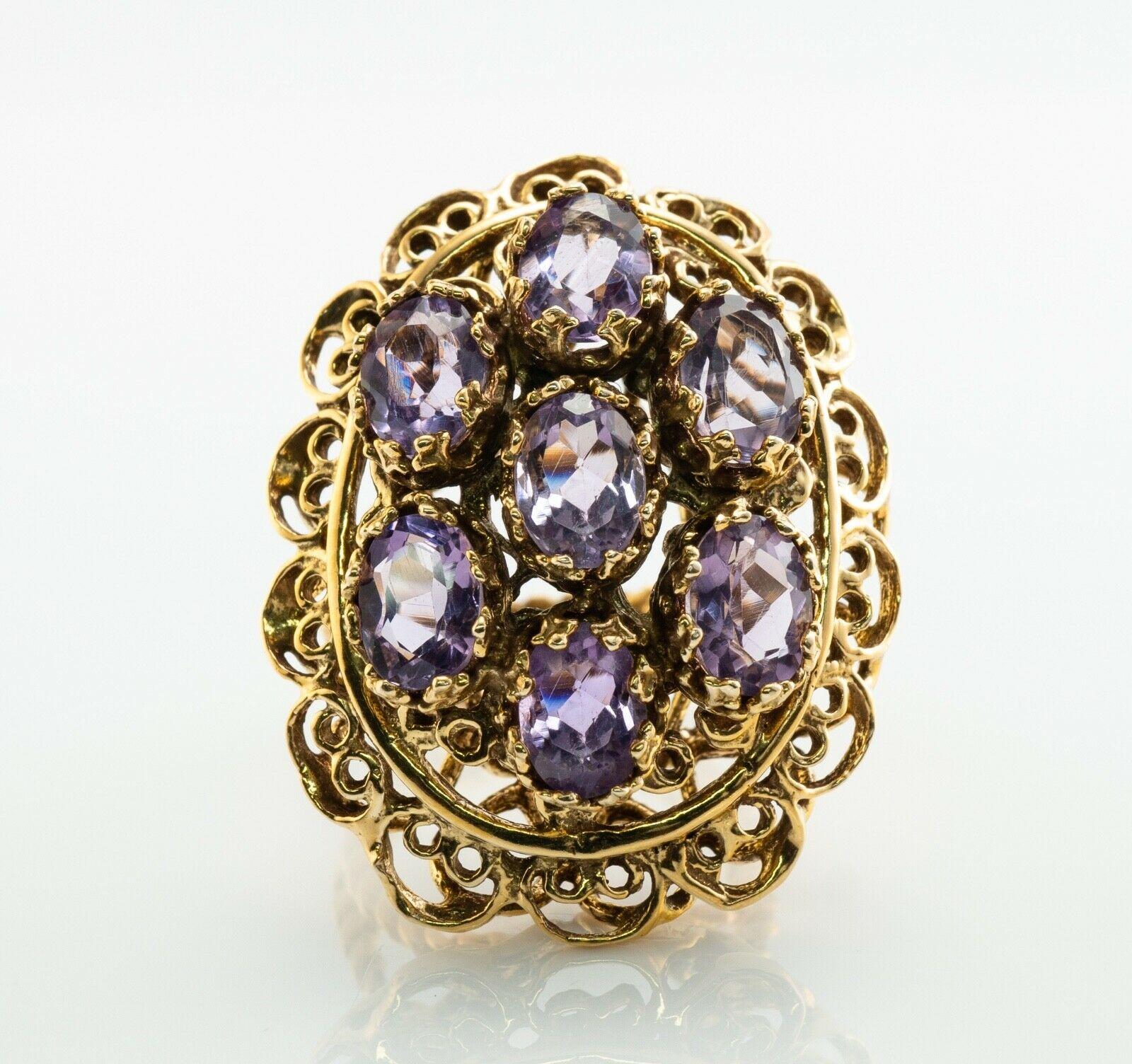 This stunning vintage ring is finely crafted in solid 14K Yellow Gold (carefully tested and guaranteed) and set with genuine Earth mined Amethysts. Seven oval cut gems measure 7mm x 5mm each totaling 5.95 carats. All stones are original to the
