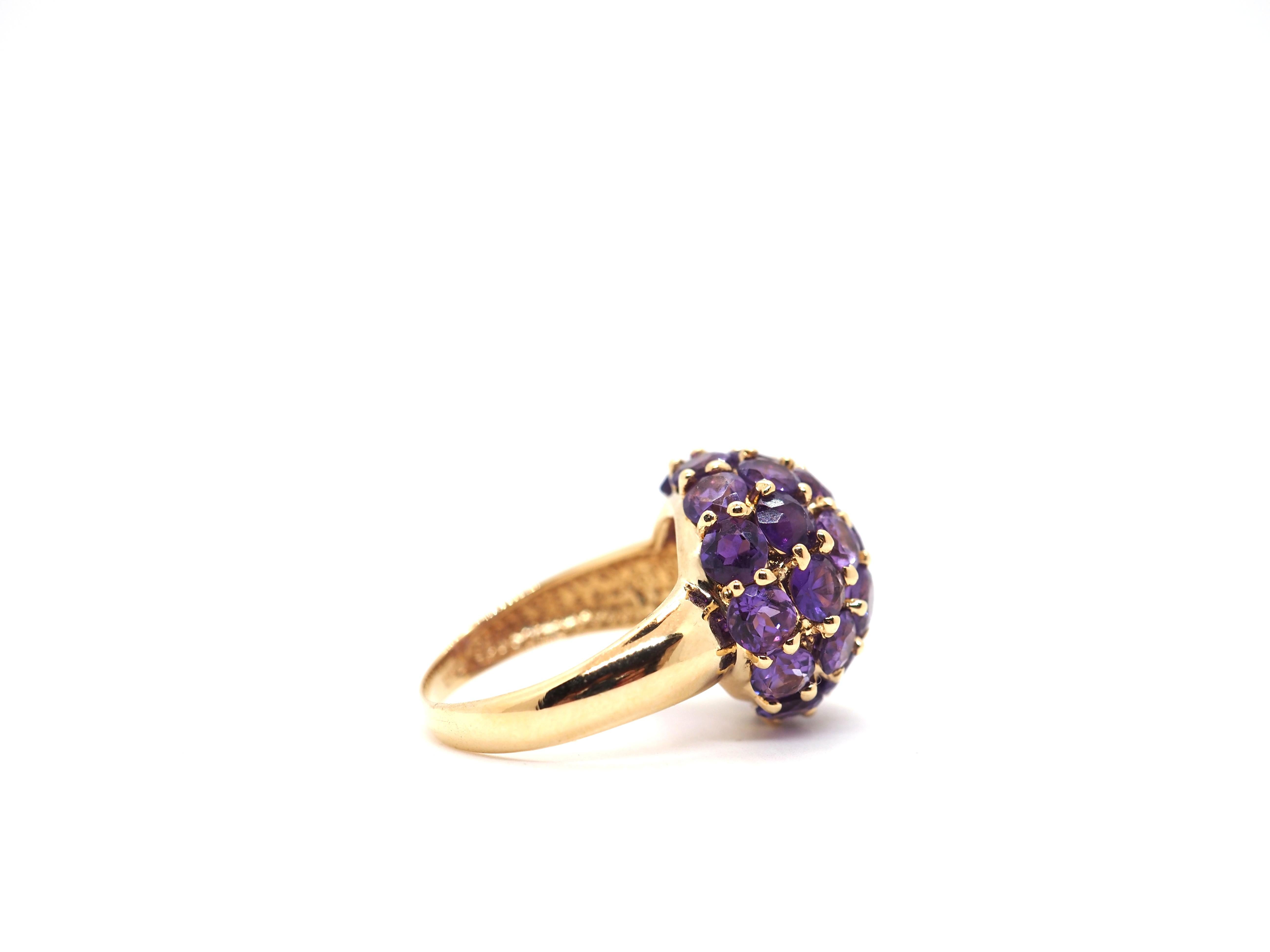 Elevate your style with our stunning 18k yellow gold cocktail ring, a masterpiece adorned with captivating round-shaped amethysts. 

Indulge in the opulence of this statement piece, meticulously crafted to showcase the brilliance of genuine amethyst