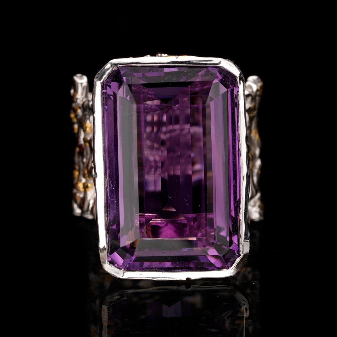This huge, flawless, deeply-hued rectangular cut amethyst is set in an intricately detailed wide sterling silver band that appears woven out of the silver for a unique and lustrous arrangement sure to spark conversation.
We resize within 10 business