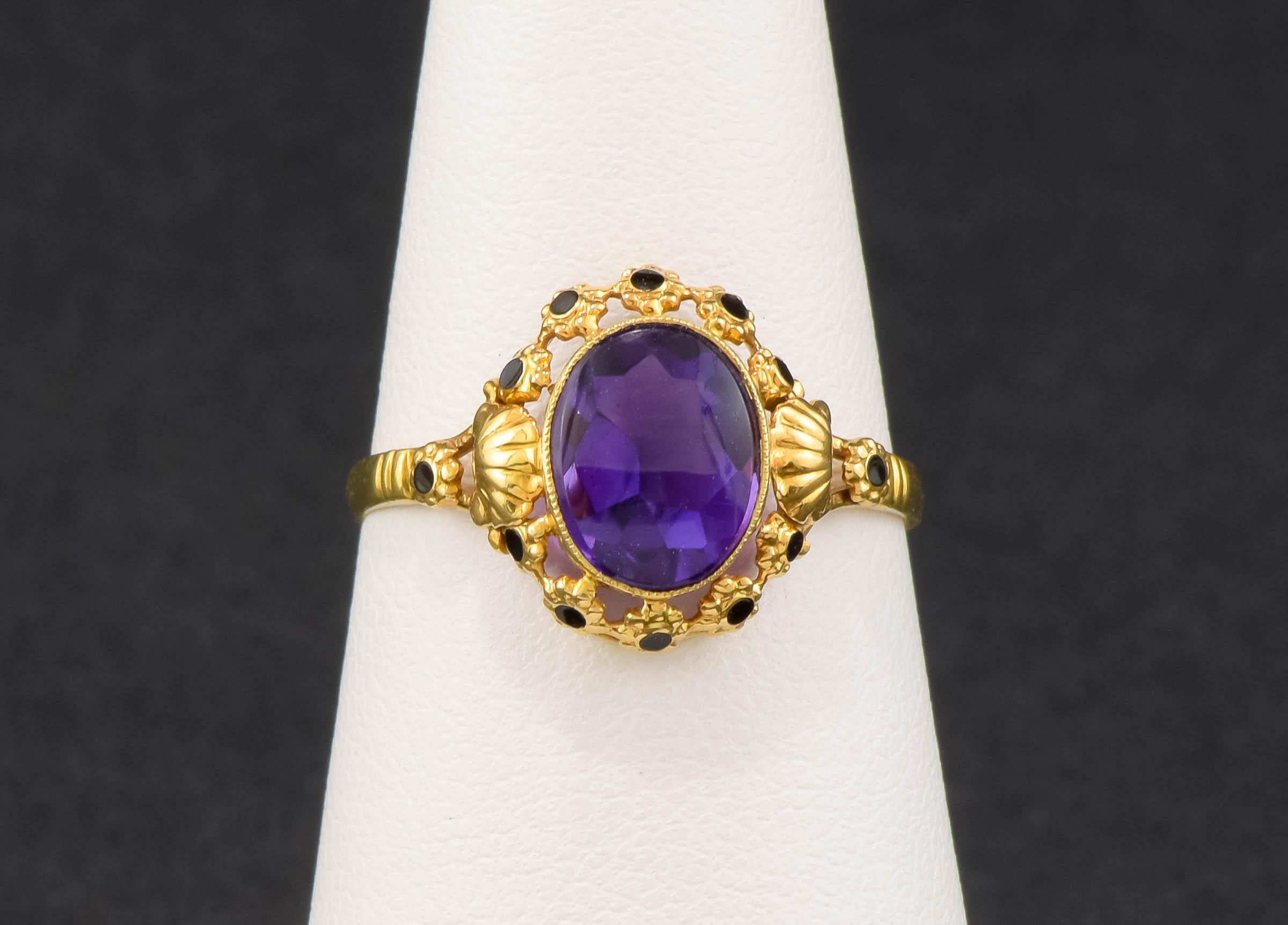 There is nothing quite like the rich purple of a fine amethyst set in high karat gold - add black enamel and beautiful details to make it really special.

Crafted of 18K yellow gold (with a small sized area at the back testing as 9K gold), the ring