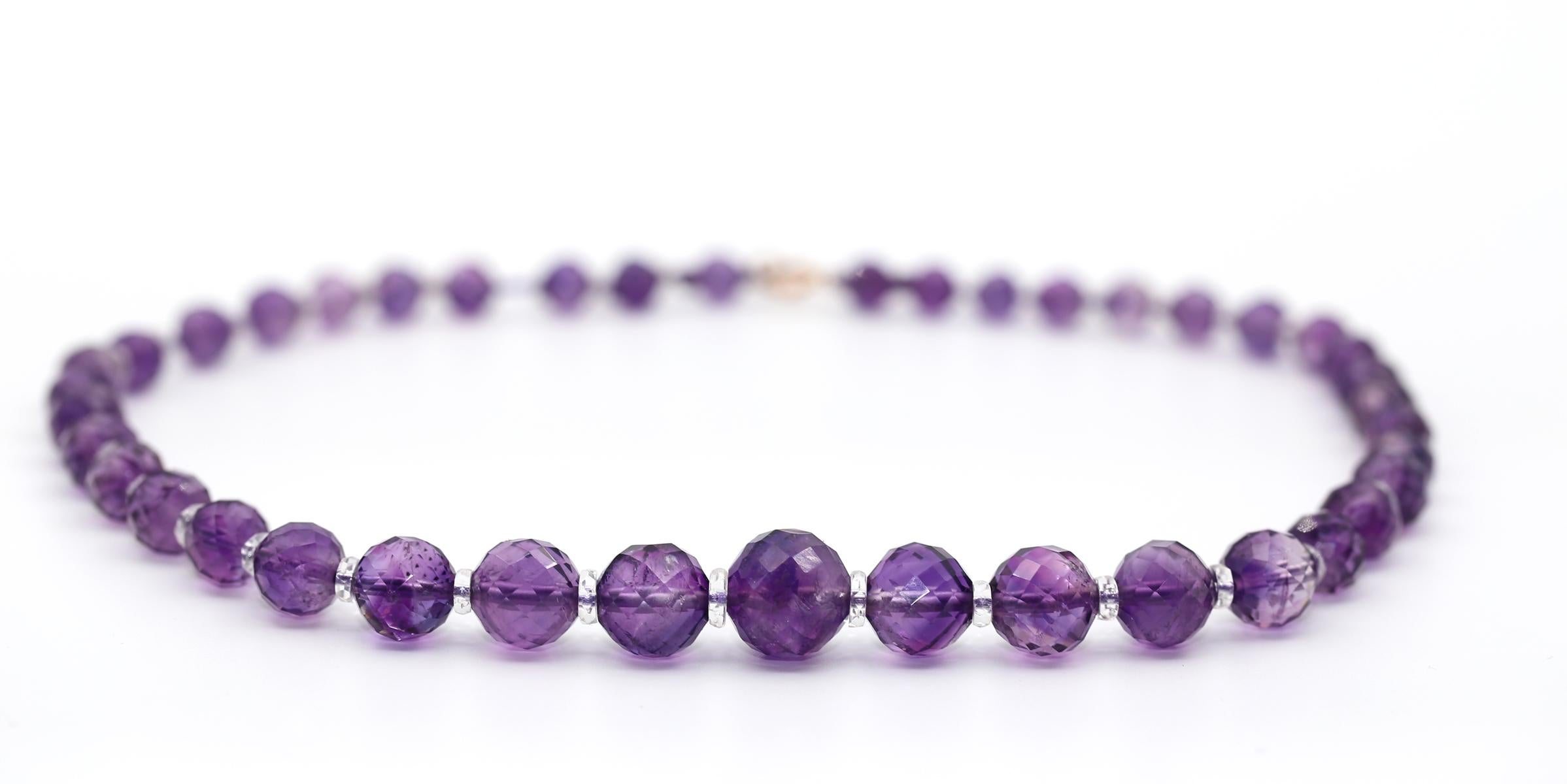 Amethyst and Rock Crystal Necklace. Created in 
Fine Amethyst Necklace with yellow gold lock, comprising a row of faceted amethyst beads accented by rock crystal beads. No assay marks. The beads are organized in descending order from the center.