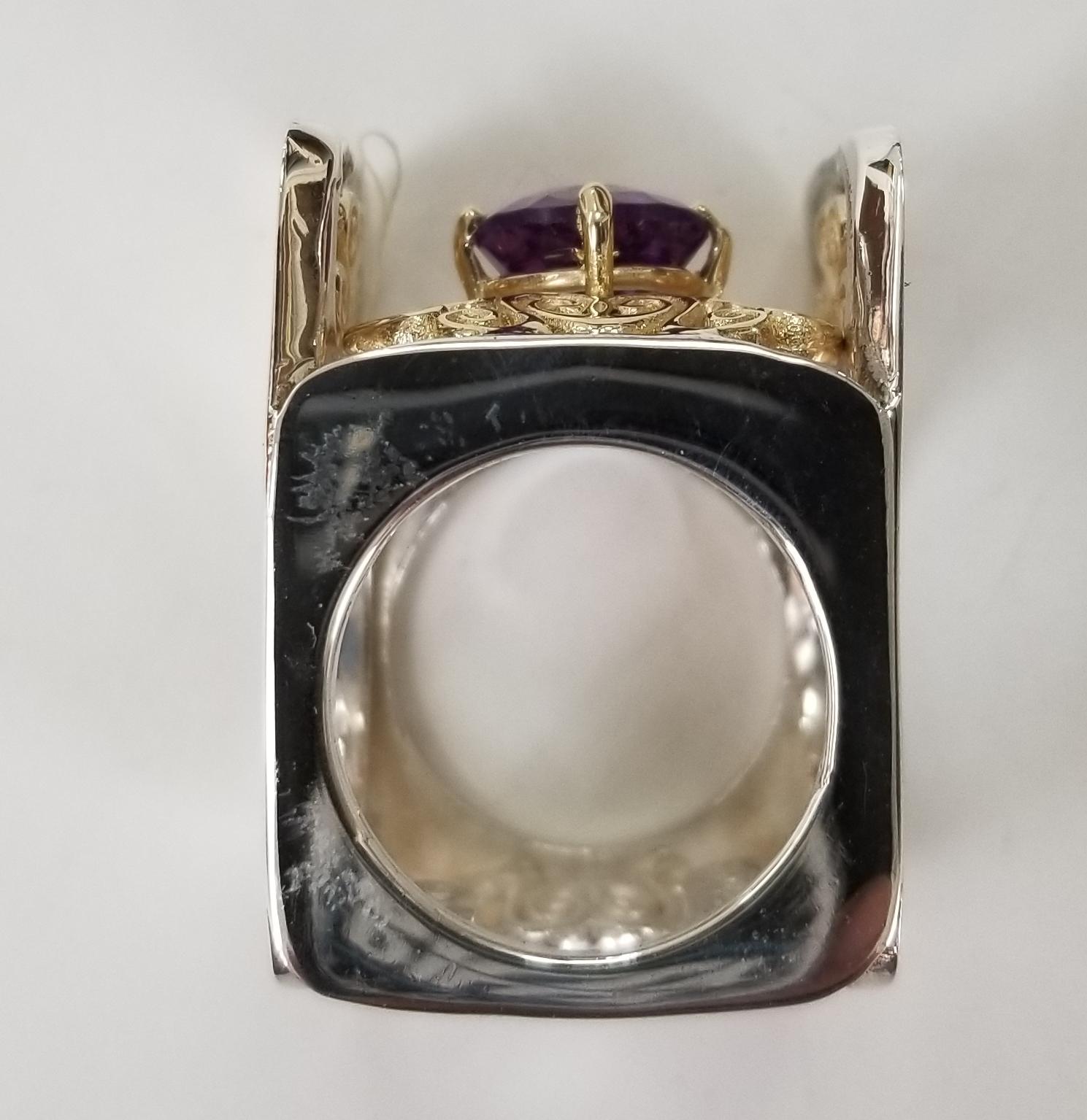 Amethyst round 2.57cts. with diamonds 14 karat yellow gold and silver, containing 4 round diamonds weighing .15pts. and 1 round amethyst weighing 2.57cts.  The ring is made to fit 2 different fingers size 6 and 8.