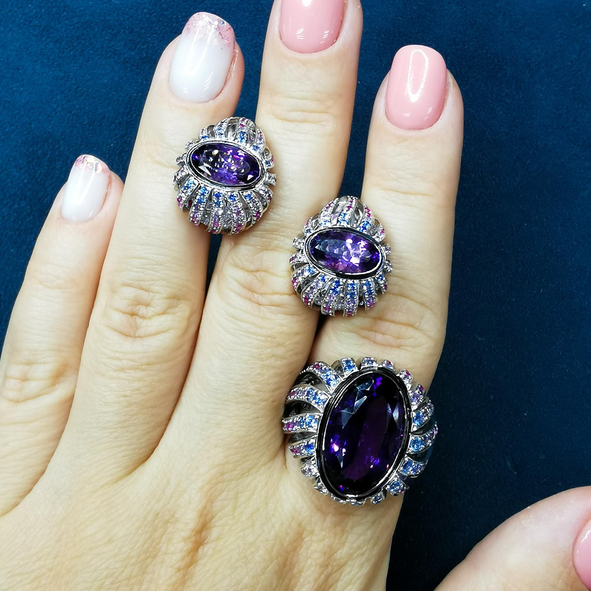 Amethyst Rubies Sapphires 18 Karat White Gold New Age Suite
An incredibly bright Oval-shape Amethysts, from which many 18 Karat White Gold paths slide down, where Pink, Blue, and Purple Sapphires and 100 Rubies are fixed. The splendor of cold shades