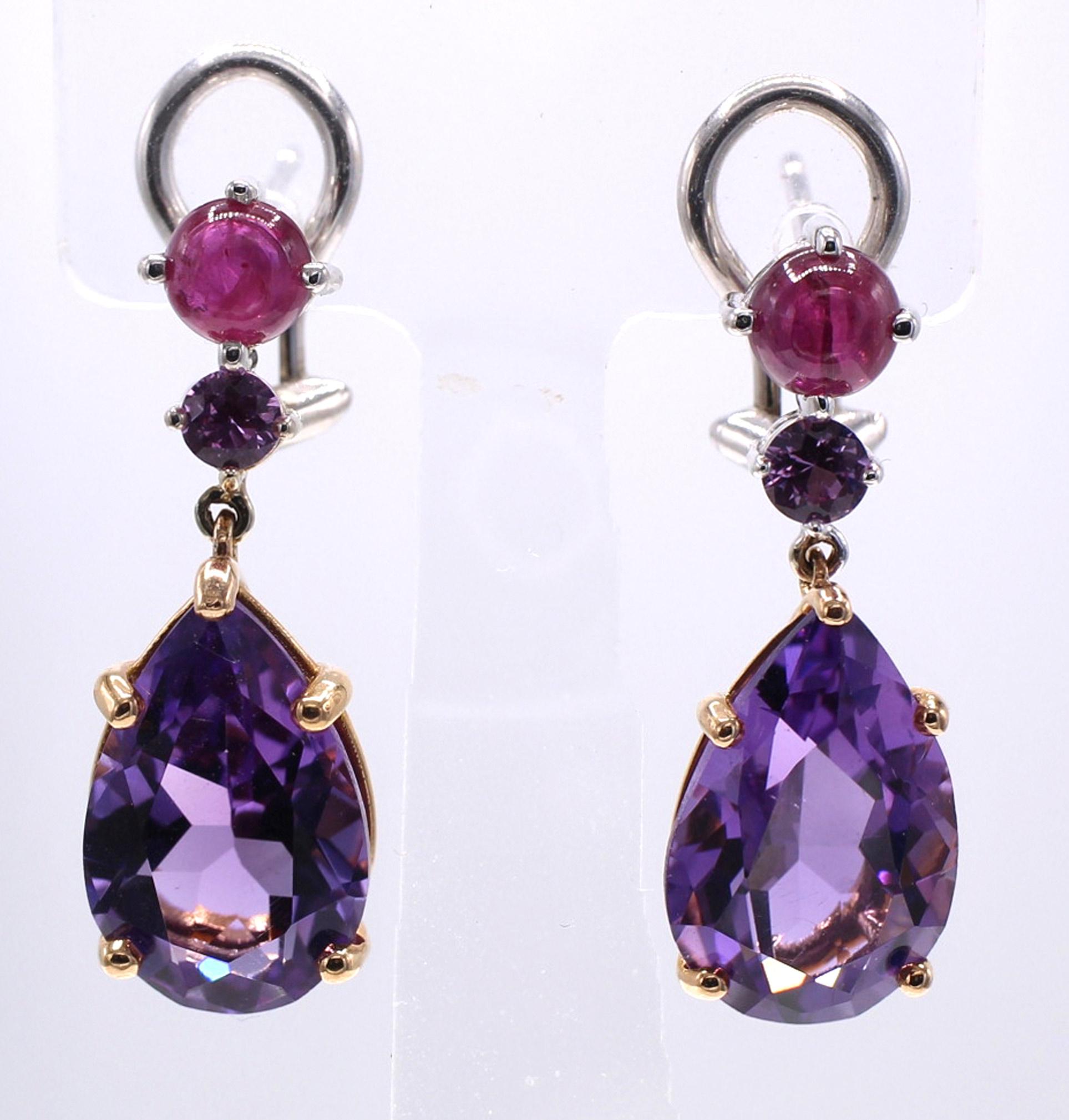 Charming and fun, colorful pendant earrings, set with one larger pear shape Amethyst set in 18 karat rose gold, a vibrant round pink sapphire and a bright red cabochon ruby set in 18 karat white gold. The Amethyst is flexibly connected to the top