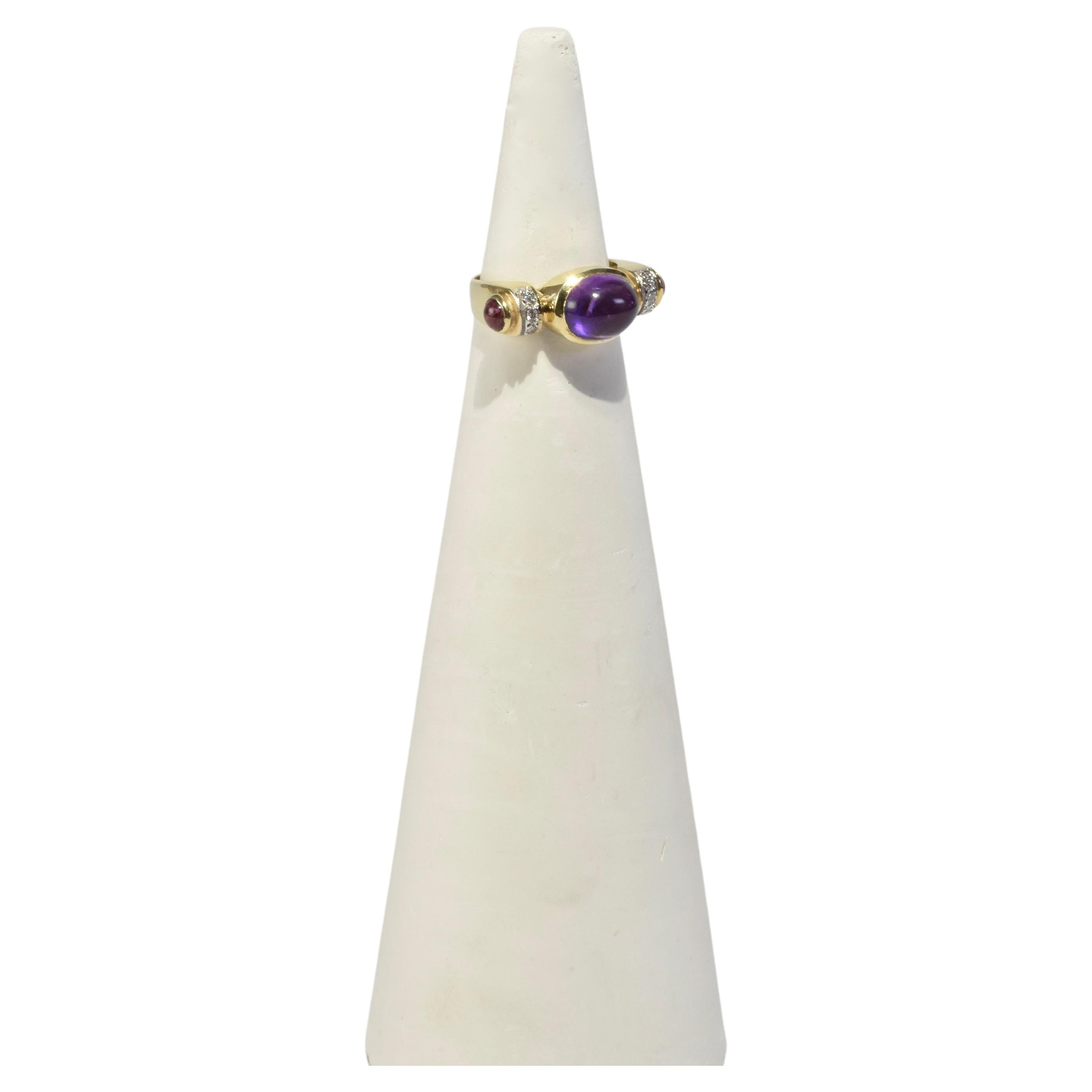 Stunning vintage gold ring with amethyst, ruby, and diamond detail. Stamped 14k.

Material: 14k gold, amethyst, ruby, diamond.