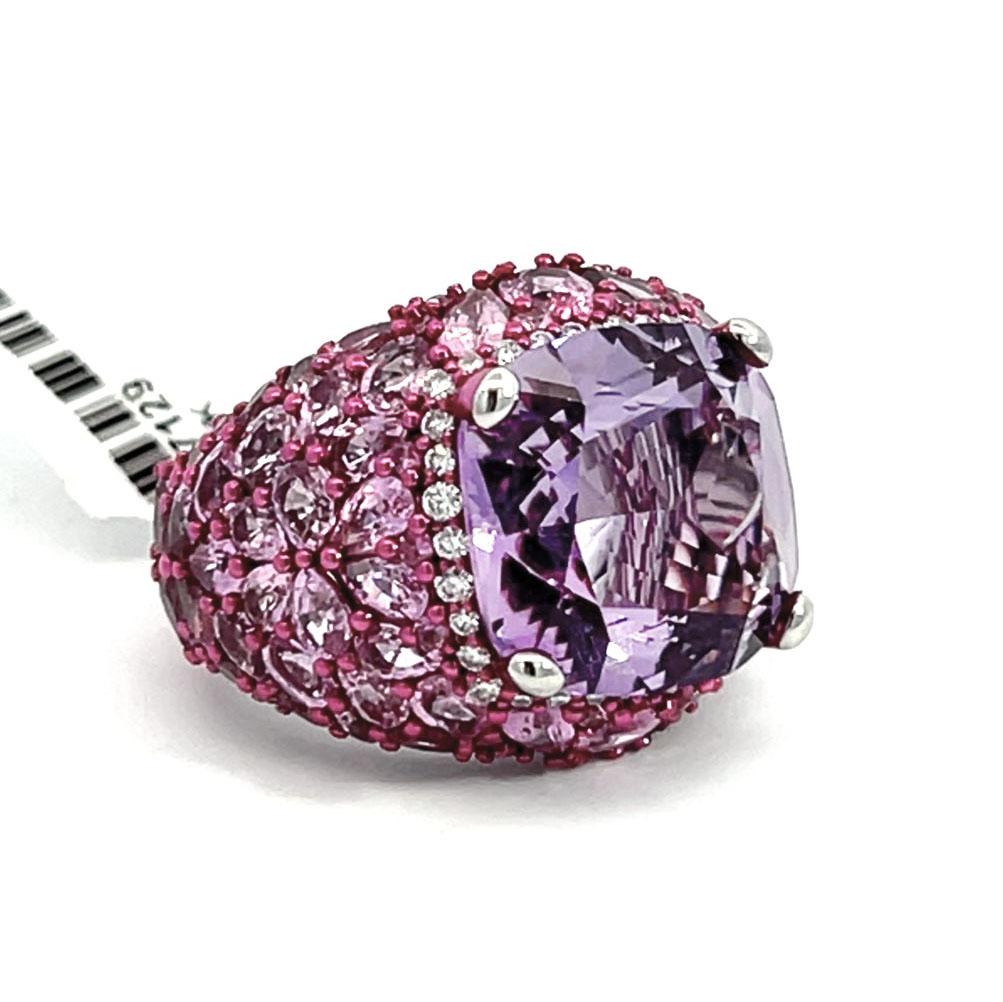 This 18k white gold Amethyst, Pink Sapphire, and Diamond fashion cocktail Ring is more than just an accessory—a statement, an invitation to showcase your unique style and unparalleled taste.
At the heart of this exquisite ring is a stunning