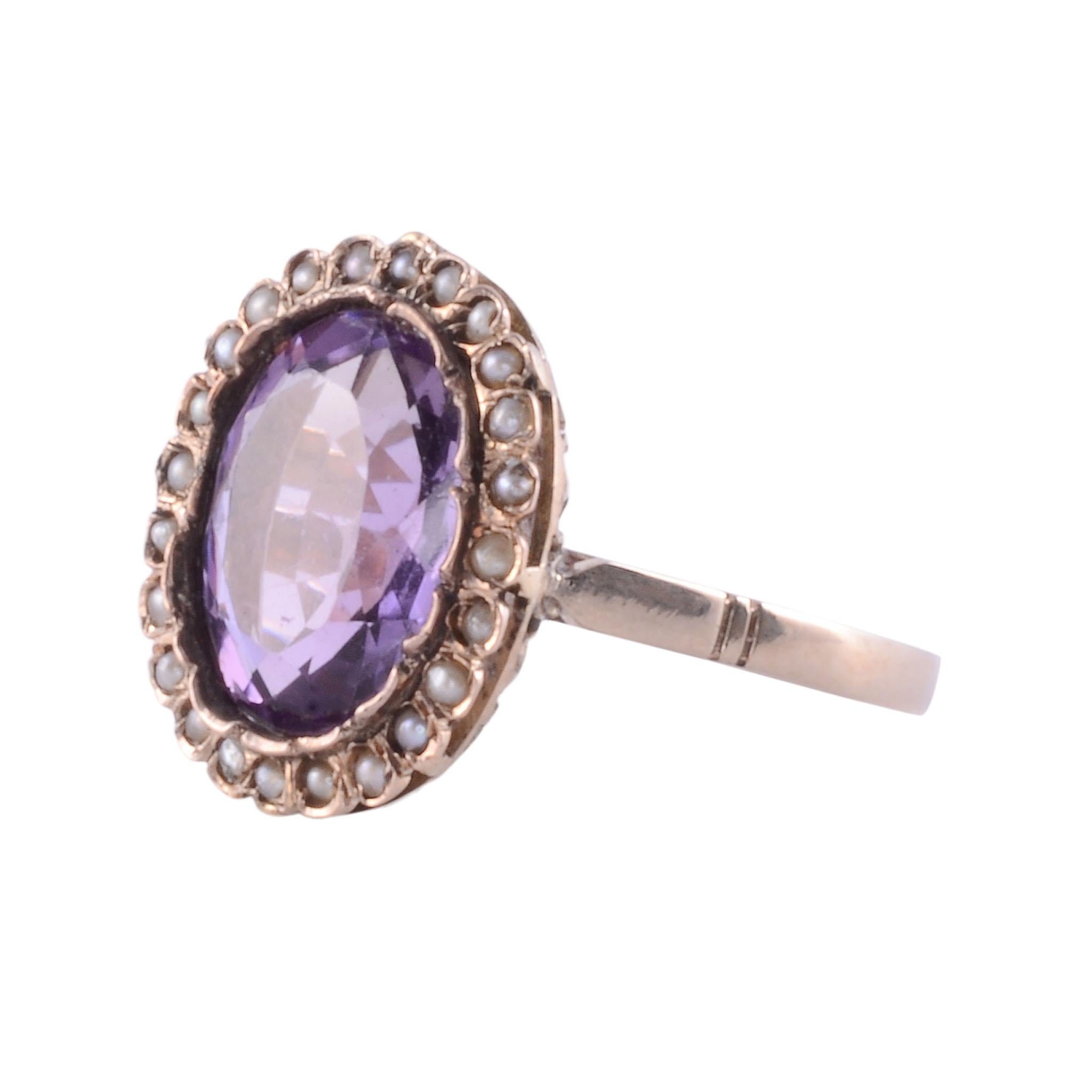 Antique amethyst seed pearl gold ring, circa 1900. This antique 14 karat gold ring features a 3.15 carat amethyst surrounded by seed pearls. The ring is a size 6.25. [KIMH 496]

*Resizing available for additional charge.