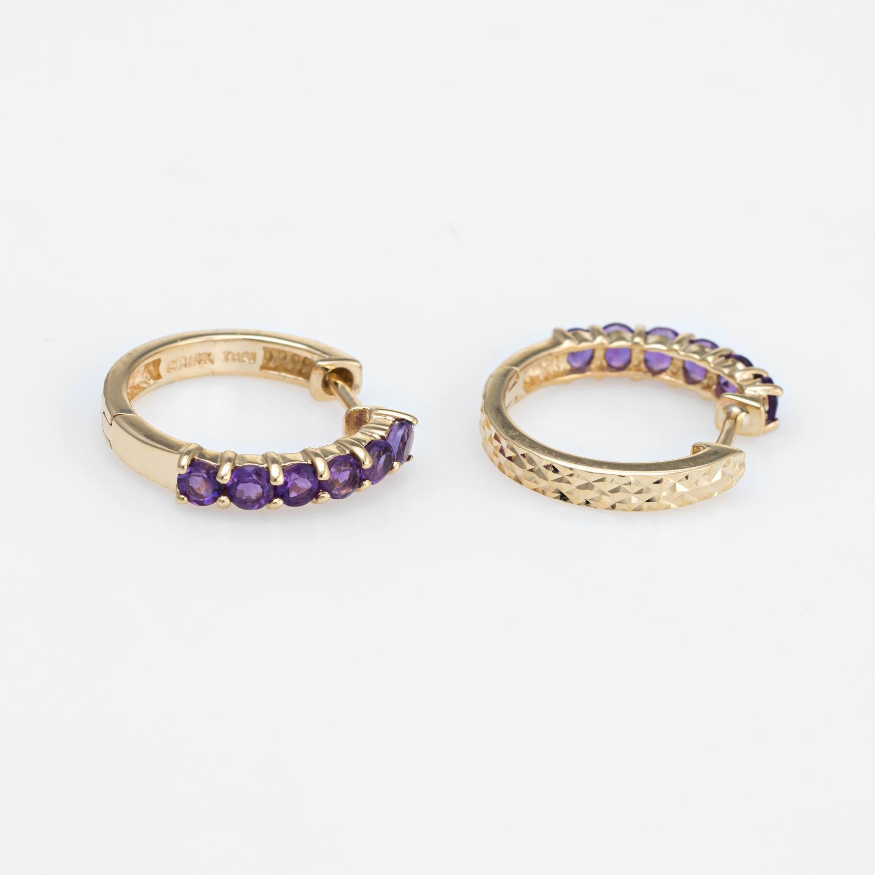 Elegant pair of estate amethyst small hoop earrings crafted in 10k yellow gold. 

12 faceted round cut amethysts total an estimated 0.36 carats. The amethysts are in excellent condition and free of cracks or chips. 

The stylish earrings feature
