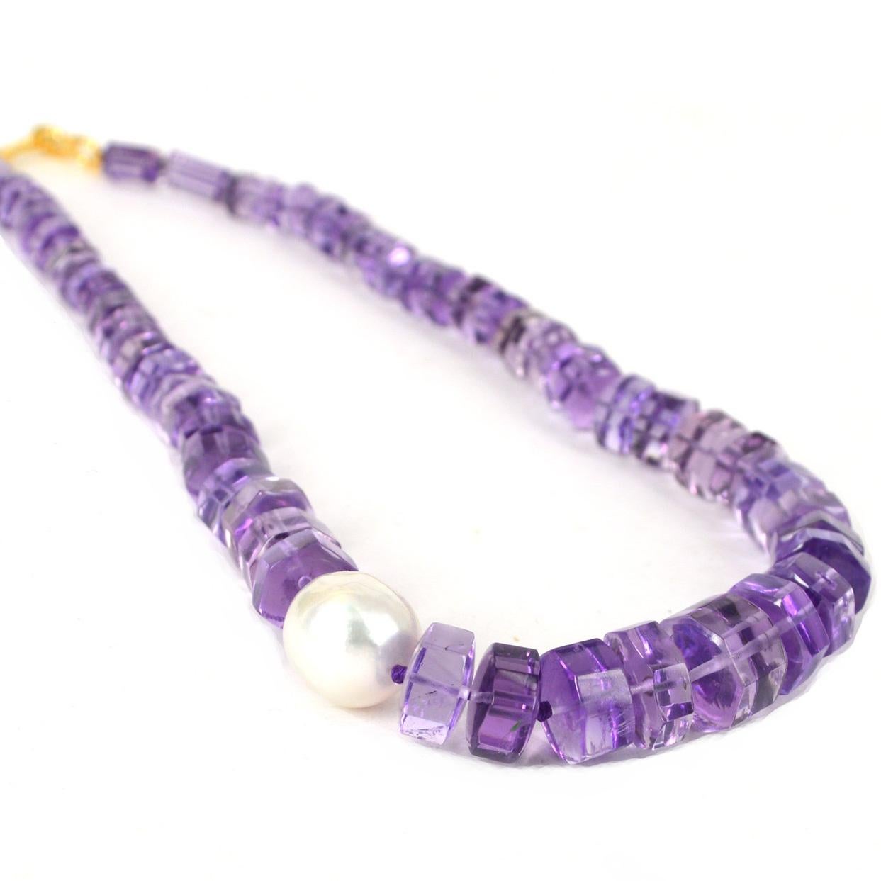 Graduated gem quality Amethyst tubes hand knotted on purple silk thread with a South Sea Pearl. Amethyst tubes measure 6x10mm up to 12x9.7mm the South Sea Pearl measures 13x14mm. Necklace is finished with a 37mm 14k Gold Filled hook clasp.
