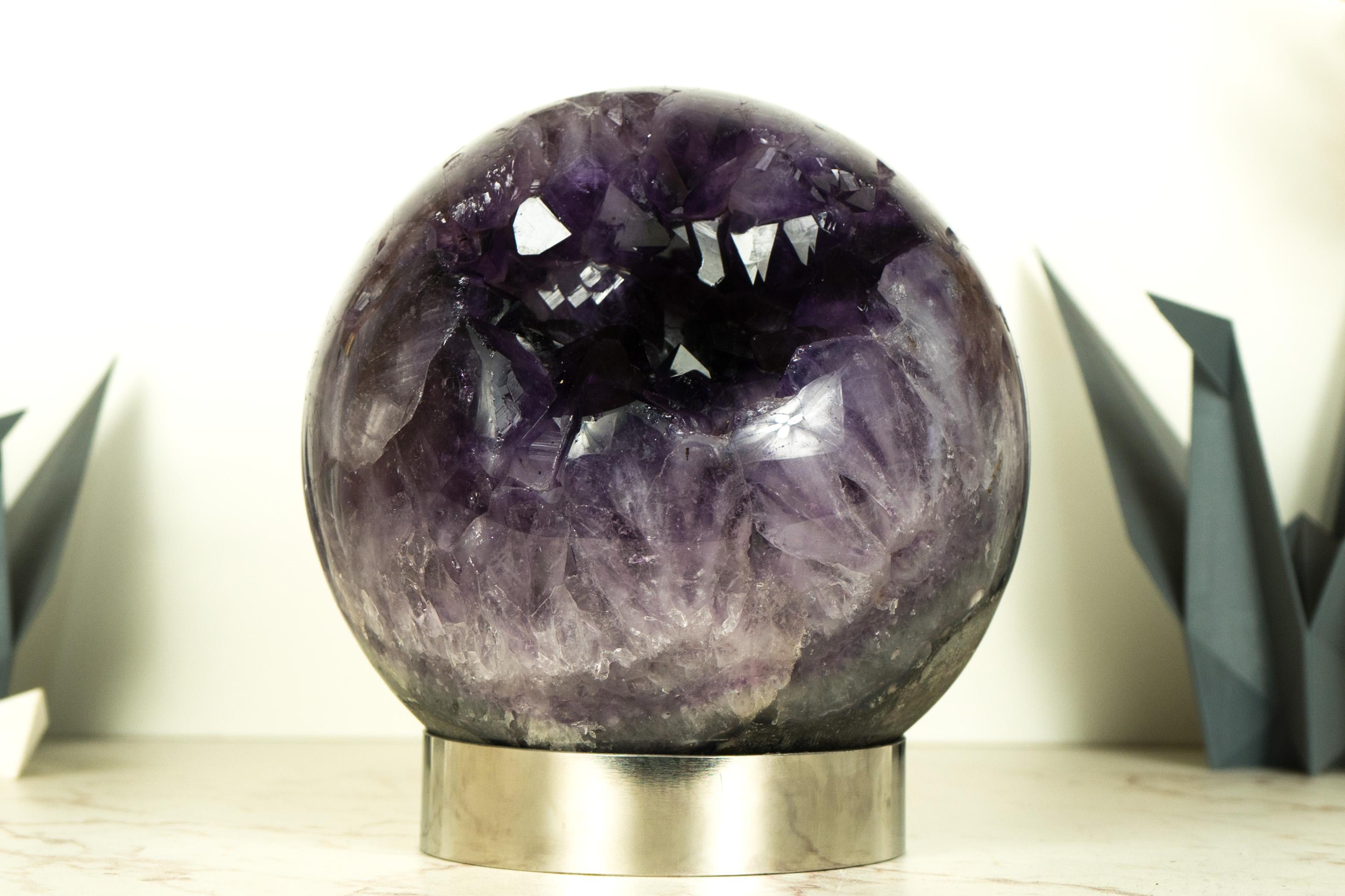 This X-Large Amethyst Sphere brings the utmost in terms of amethyst color, X Large size of the points and size of the specimen itself, and the overall gorgeous aesthetics of the sphere. Its exceptional size and superb quality make it a truly