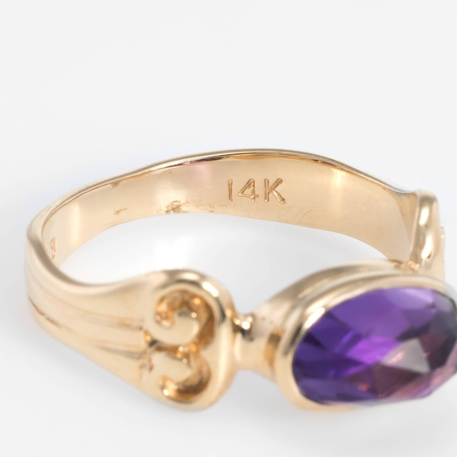 Elegant vintage stacking ring, crafted in 14 karat yellow gold. 

Checkerboard faceted amethyst measures 9.75mm x 5.5mm and is estimated at 1.25 carats. The amethyst is in excellent condition and free of cracks or chips.   

The ring is in excellent