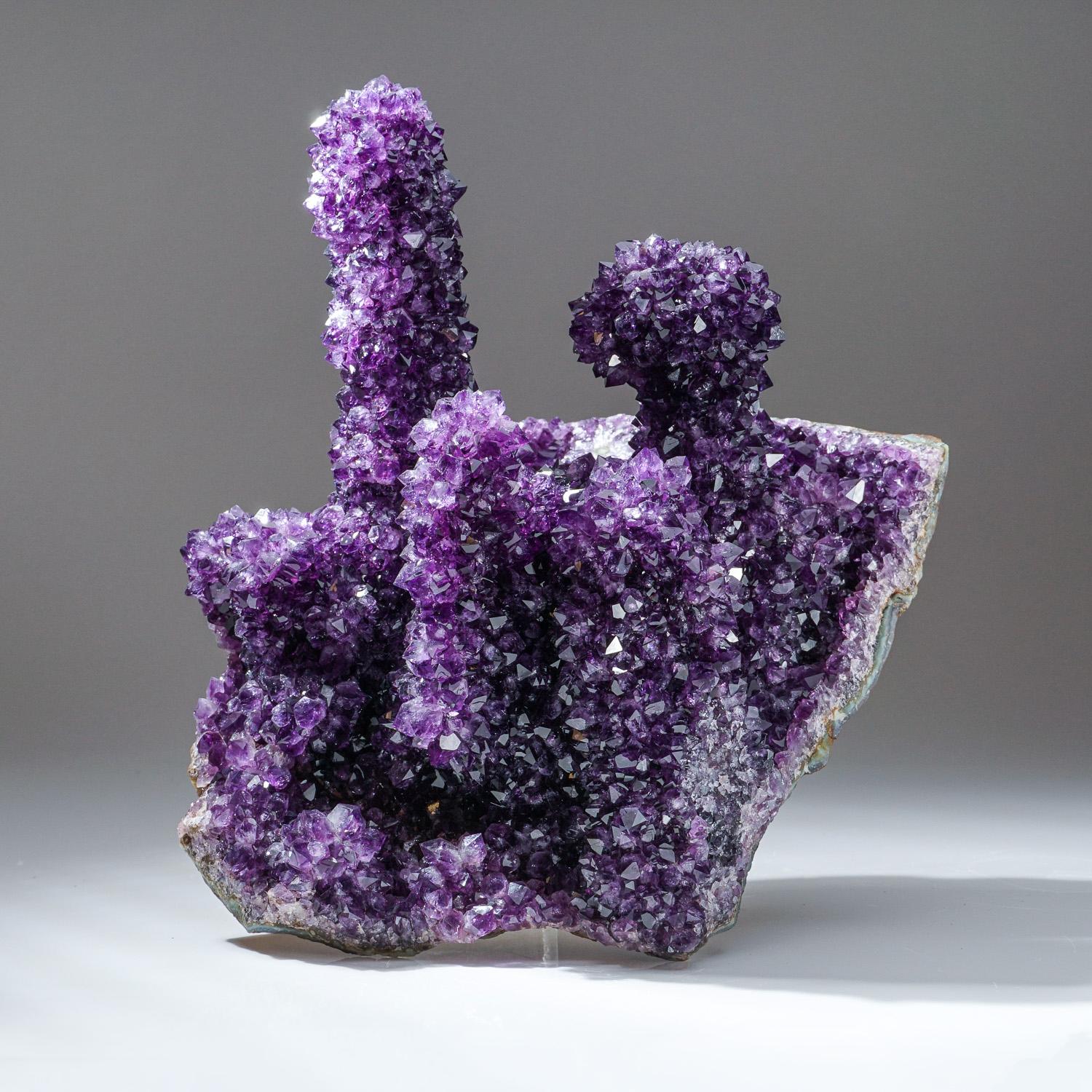 This specimen is a world-class, museum-quality stalactite form of the finest gem-quality Amethyst - from the famous regions of Artigas, Uruguay. This specimen is showing huge, stalactite formations, inter-locking in a cluster, and displaying top