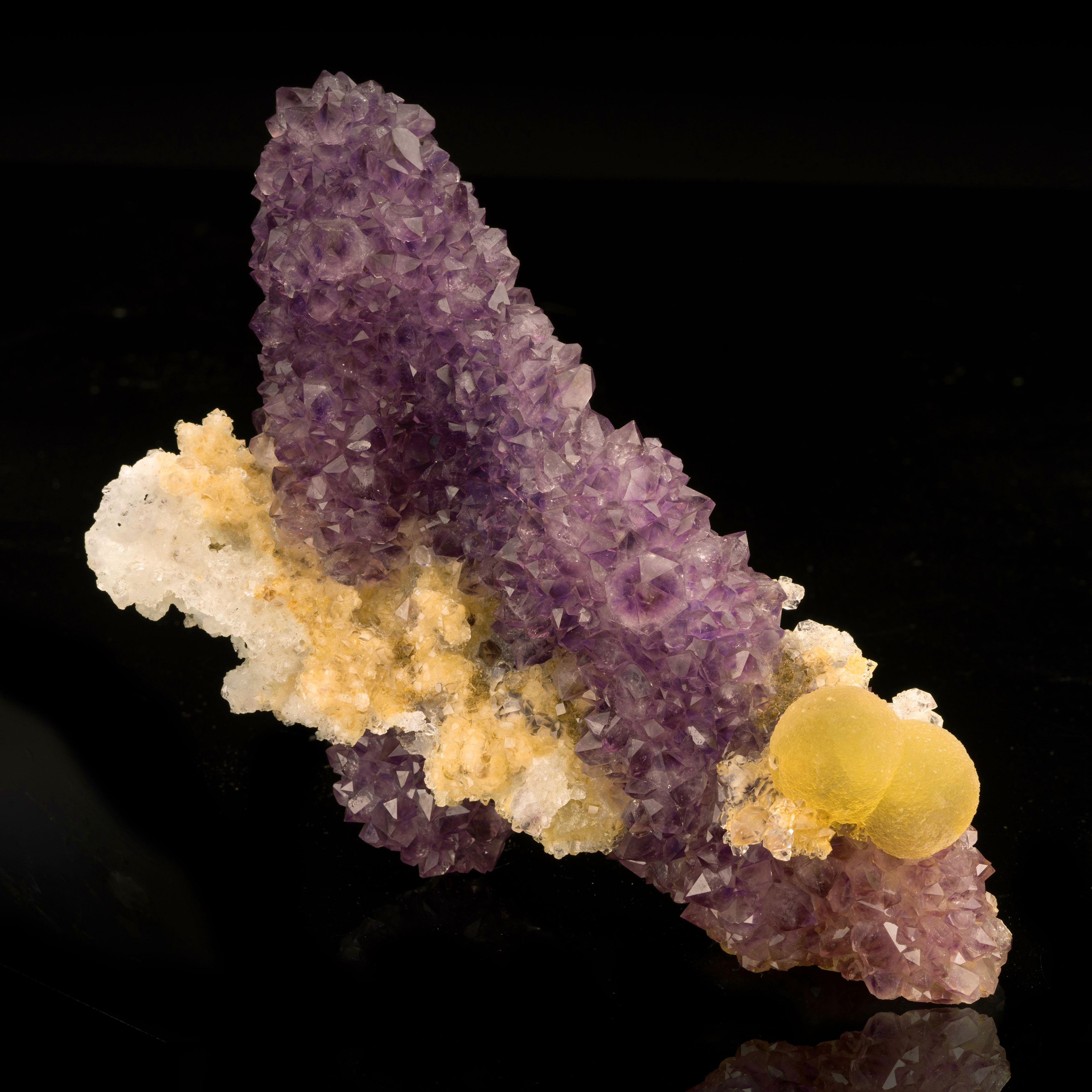 Puna, India

This amethyst stalactite is uniquely shaped like a fashionable high heel and is accented by two botryoidal fluorite spheres that are perfectly placed to resemble a stylish shoe clip as well as by a calcite cluster that juts out at the