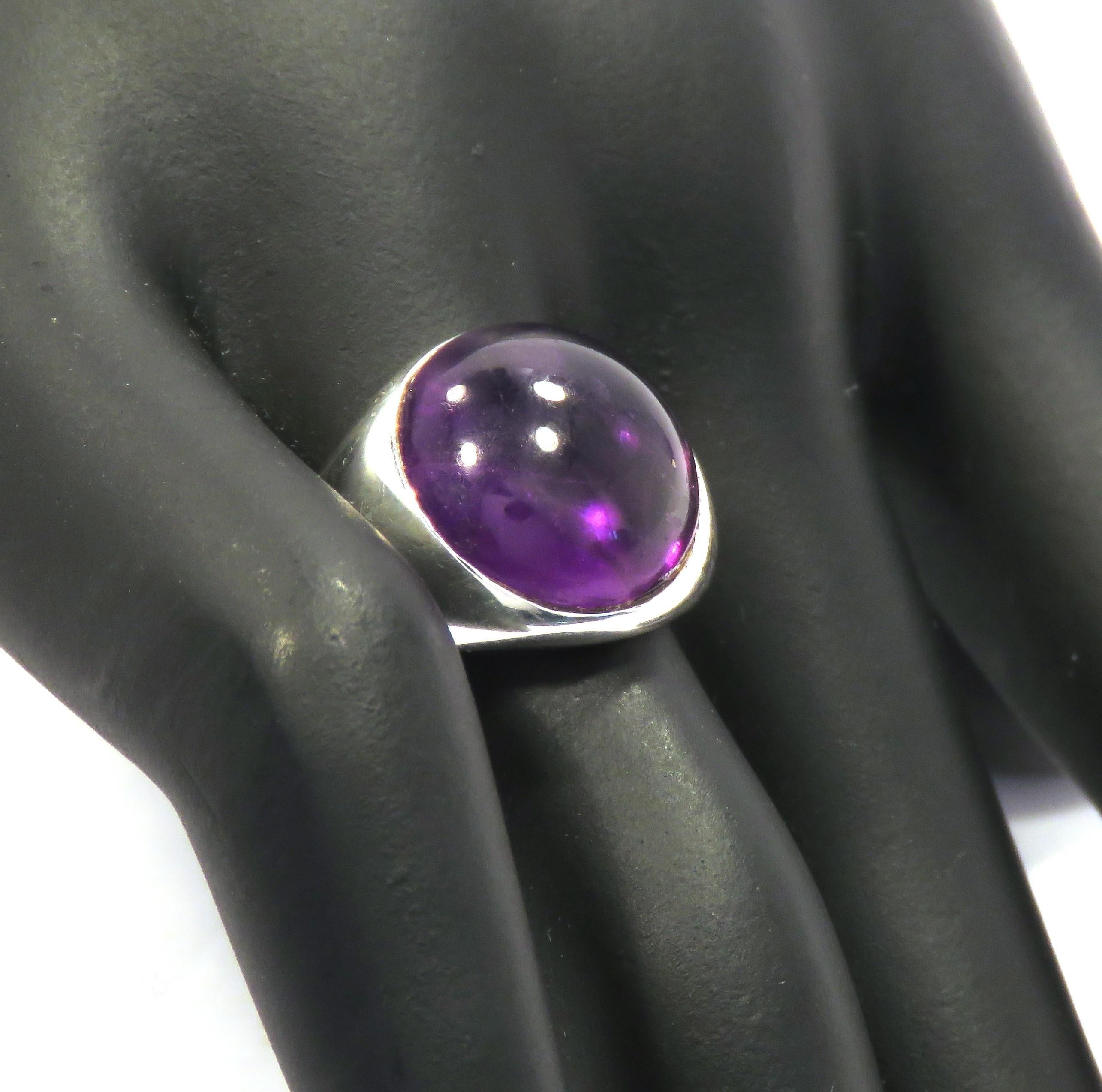 Beautiful cabochon cut amethyst in a contemporary band ring crafted in sterling silver. The size of the gemstone is 14x14 mm / 0.551x0.551 inches. US finger size is 7, French size 55, Italian size 15, resizable to the customer's size before