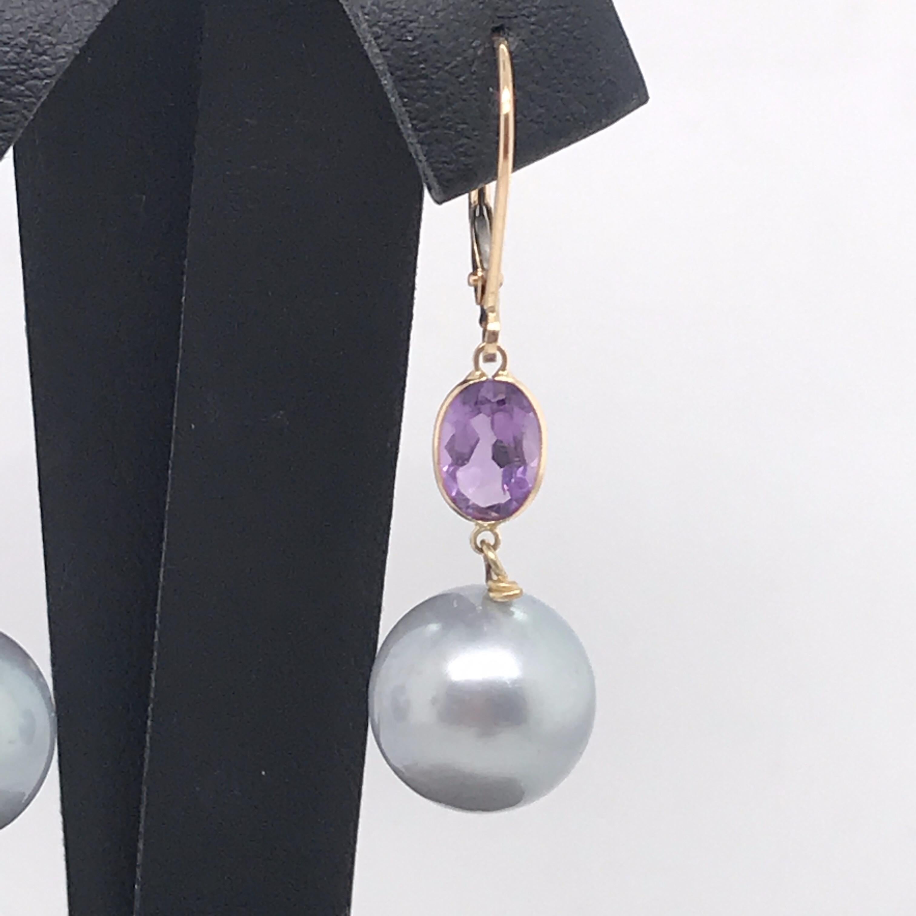 14K Yellow drop earrings featuring two oval Amethysts and two grey Tahitian pearls measuring 11-12mm.
Can customize different pearls and semi-precious stones. 