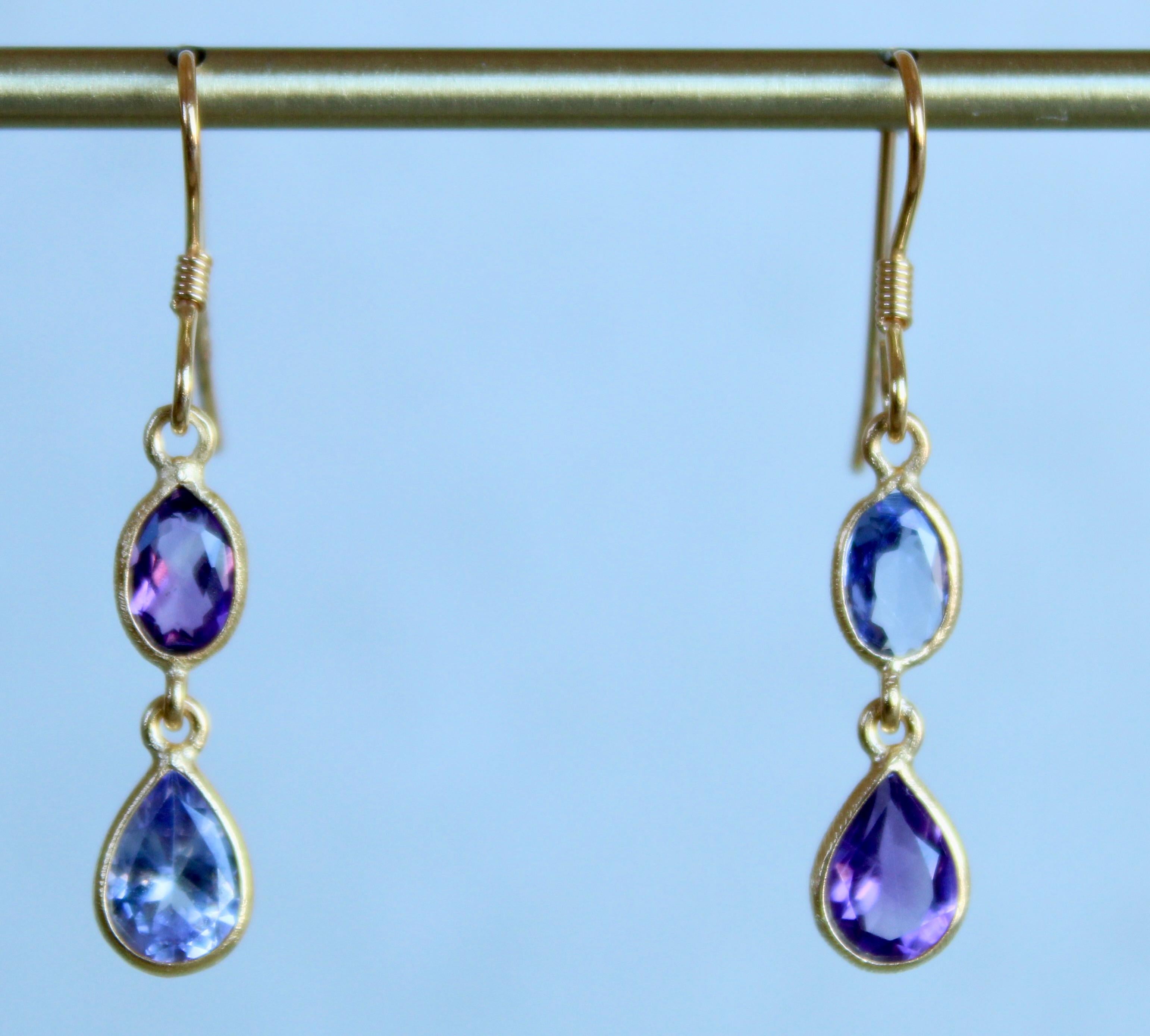 This unique pair of earrings from Oiseau Bleu is comprised of amethyst and tanzanite. These earrings are made to be worn on either side as a pair or as a single. The left side is shown is with an oval Amethyst and the bottom with a Tanzanite pear.
