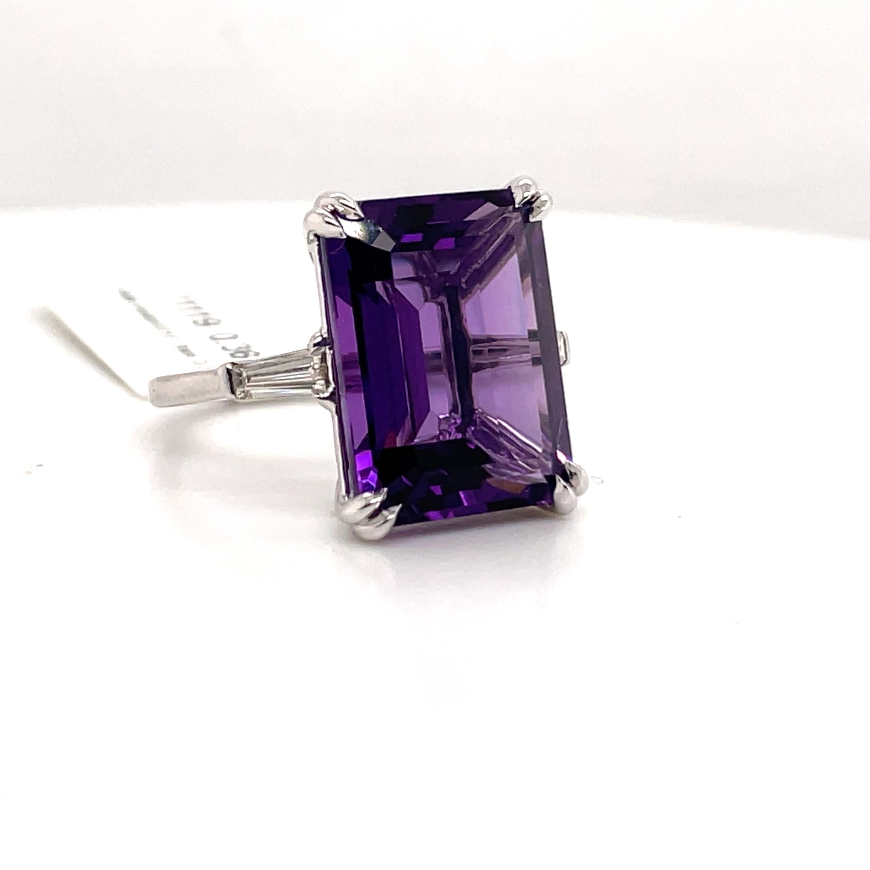 14 Karat White gold ring featuring one Emerald Cut Amethyst weighing 1-.57 carats flanked with two tapered baguettes weighing 0.36 carats. 
Color G-H
Clarity VS
