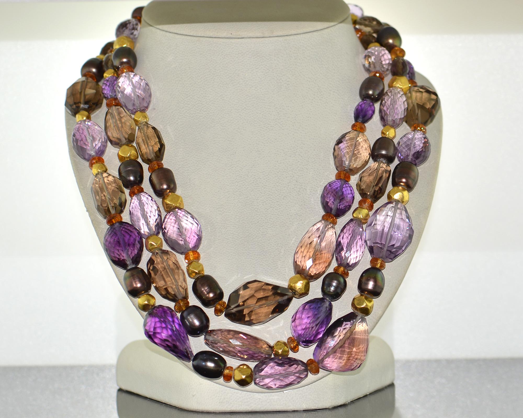 Beautiful necklace embellished with amethysts, topaz and colored pearls. 
Mounted in 18K yellow gold. 
Multi-strand. 