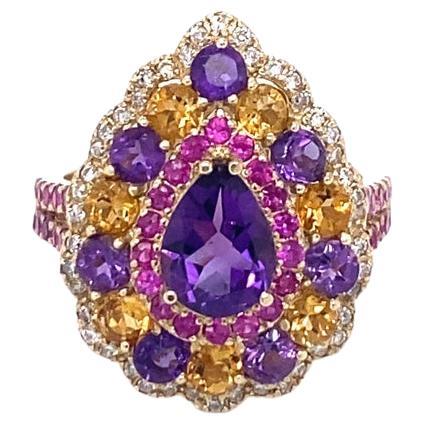 This one of a kind piece has been carefully designed and curated by our in house designer!

This ring has a deep purple Pear Cut Amethyst that weighs 0.91 Carats and is embellished with 14 Yellow Topaz and Amethysts that weigh a total of 1.34 Carats