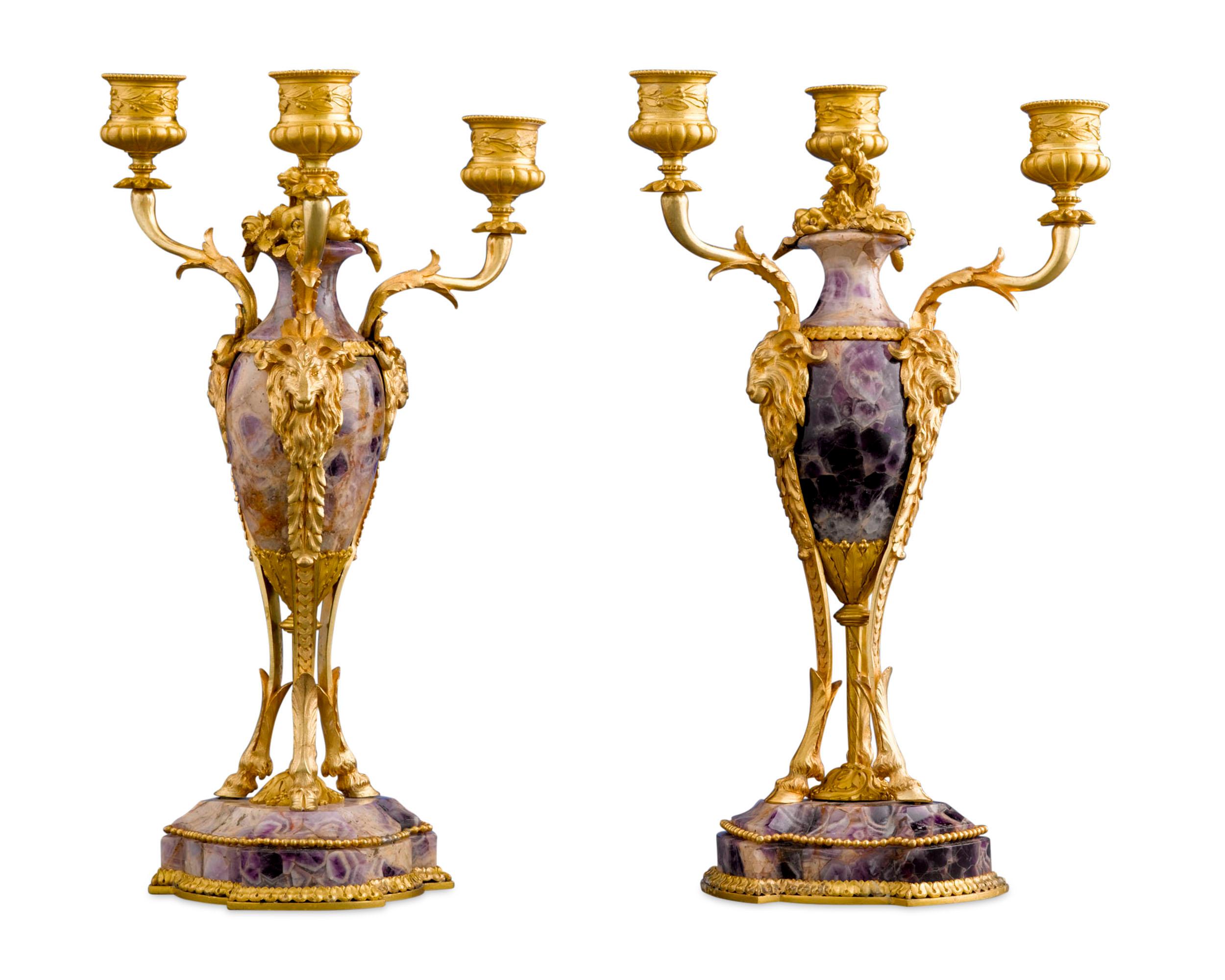 In these dazzling candelabra, beautiful amethyst is complemented by high-caliber ormolu mounts. The central body and pedestal of each are hewn from the desired purple gemstone are elegantly adorned with autumnal ornaments such as ram's head
