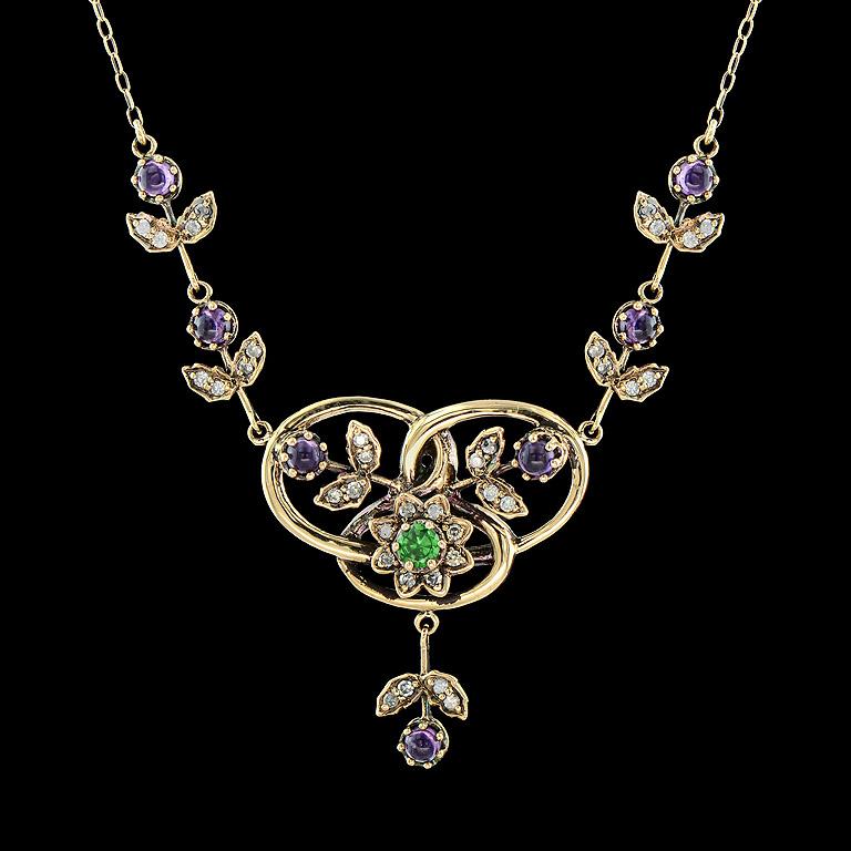 Vintage style Necklace replica from Victorian Era 19th

Center Tsavorite (Green Garnet) weighs 0.26 Carat.  
Cabochon Amethyst 7 pieces 1.53 Carat.
Diamond 36 pieces 0.49 Carat.

This item was made in 14K Yellow Gold length 16