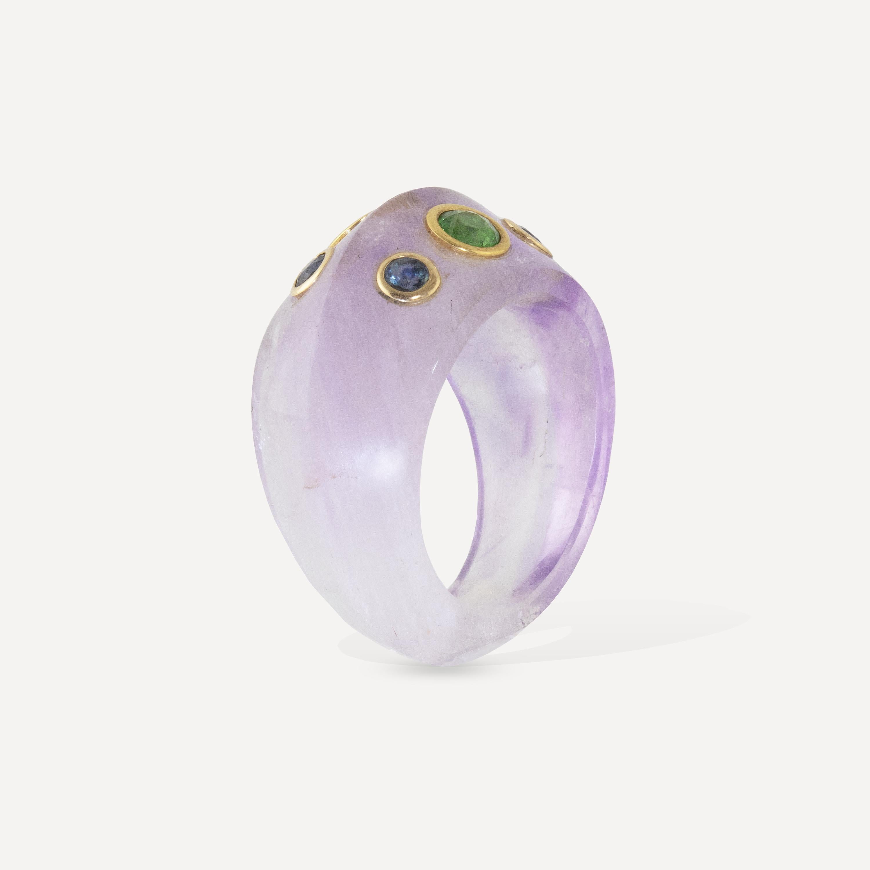 One of a kind Carved Amethyst with Tsavorite Garnet and Sapphire gemstones set in 18k gold.
The ring was hand carved using 28 carats of Amethyst.  The ring has 4 blue sapphires (.32 carats) and 2 tsavorite garnets (.42 carats) set in 18k gold