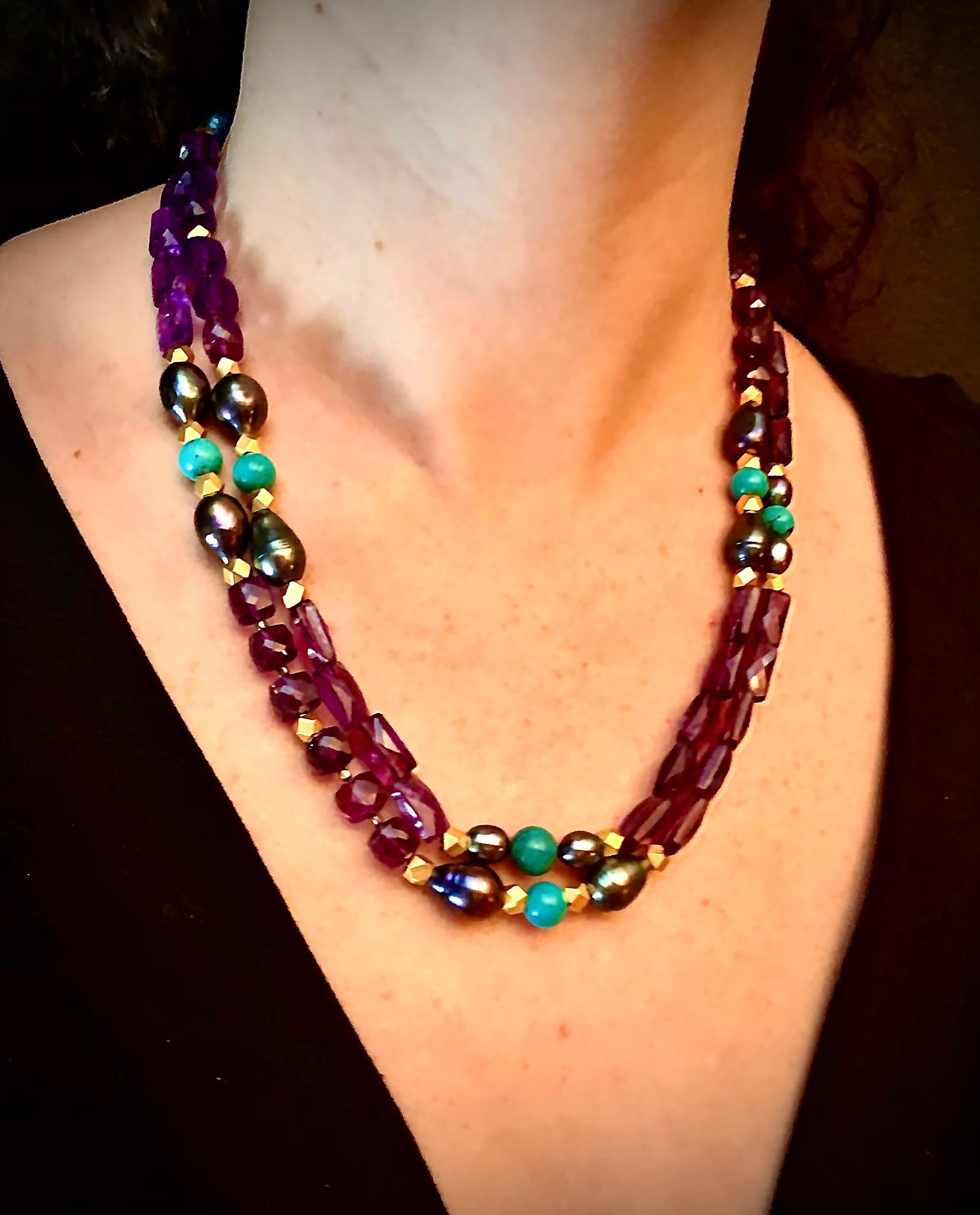 Long very smart single strand sautoir of multi cut faceted beautiful rich colored amethysts accented with brilliantly colored turquoise beads flanked with pear shaped black cultured freshwater pearls. The whole necklace has matte gold finish metal