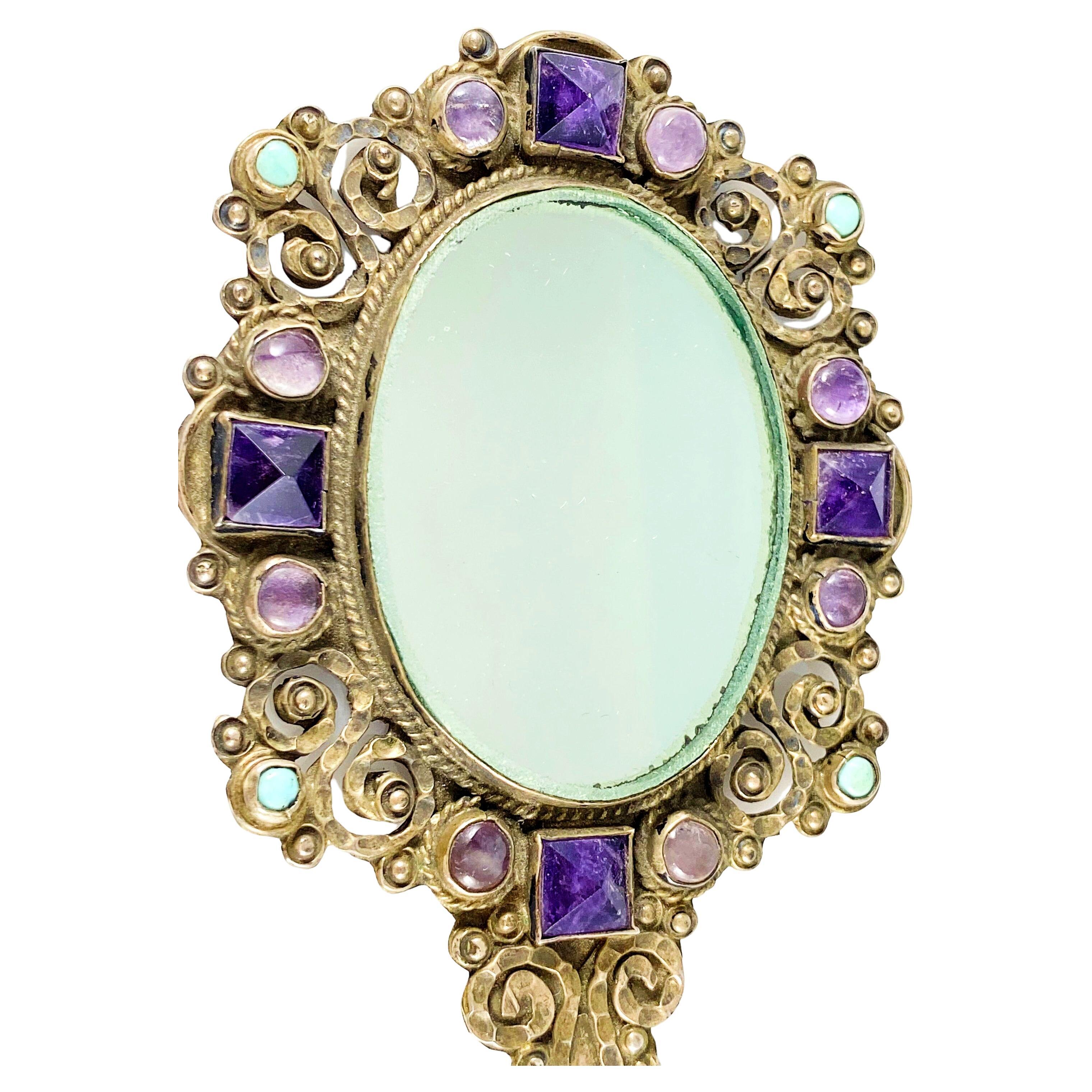 A gorgeous vintage Matl Salas sterling silver vanity mirror, hand-set with 8 lavender amethyst cabochons, 4 deeper purple amethyst pyramid-cut stones, and 4 small turquoise cabochons. This petite, sweet hand mirror features elaborate hand-chased