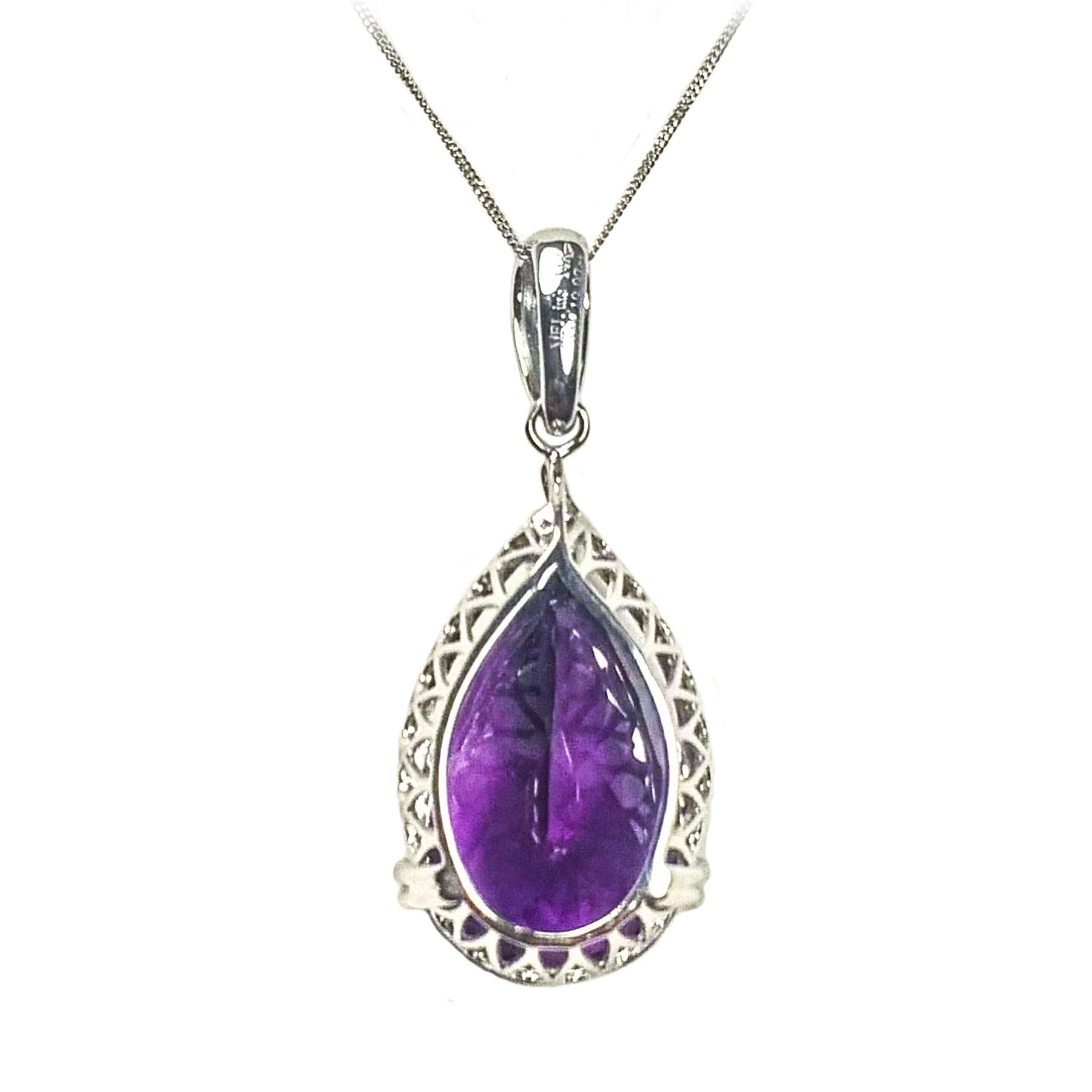 Elegant purple amethyst and diamond pendant. Contemporary, handcrafted intense purple, transparency and luster,  pear shape amethyst encased in basket mounting with four bead prongs and split prong. Encased in round brilliant cut diamond design with