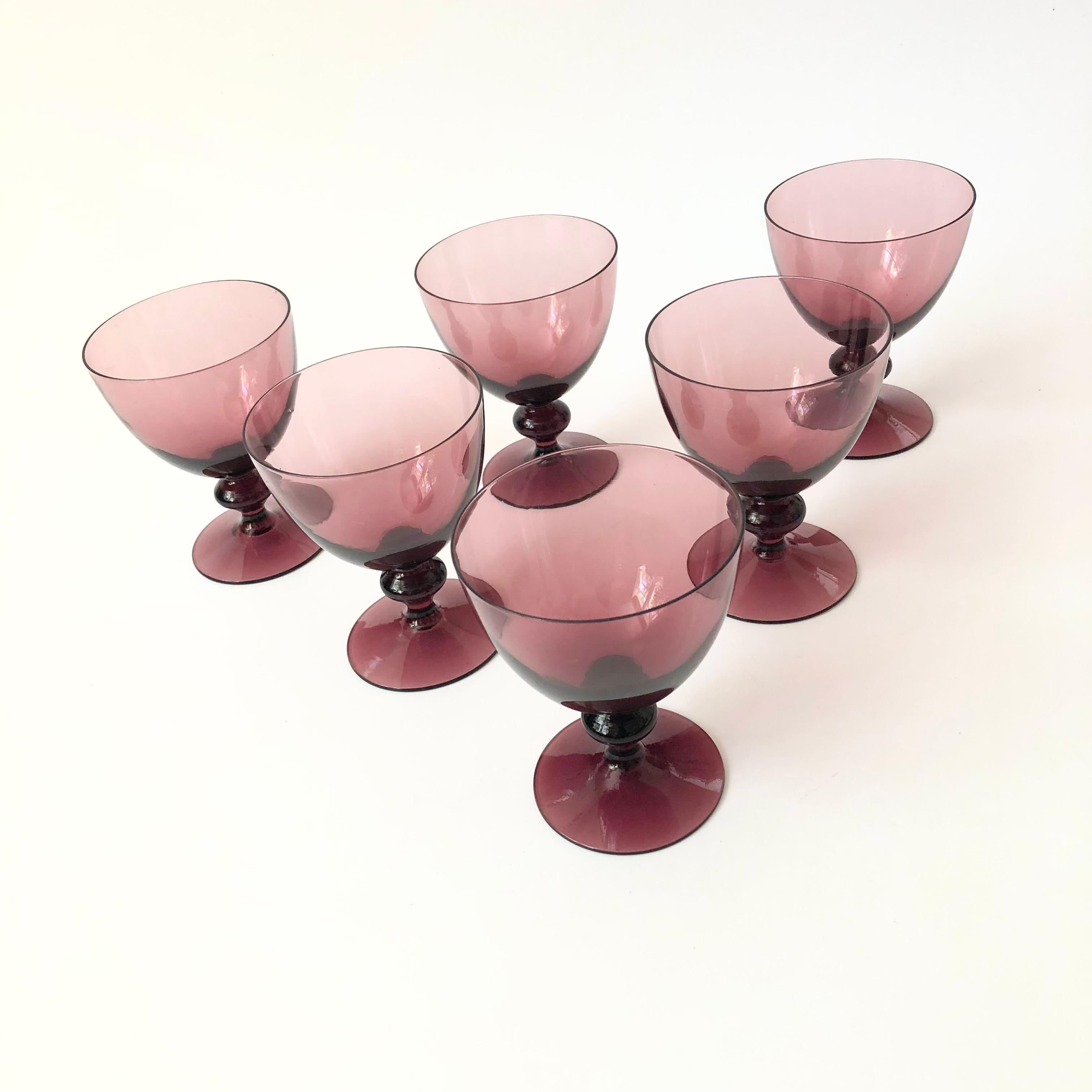 A set of 6 vintage wine glasses made out of moody amethyst colored glass. 

