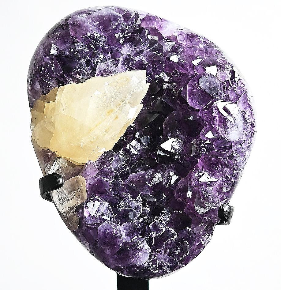 Amethyst with Calcite Geode Natural Specimen, 8.8 LBS on Stand

Offered for sale is a natural geode specimen that showcases a beautiful combination of purple amethyst and calcite gemstones. With its unique formation, all amethyst and calcite