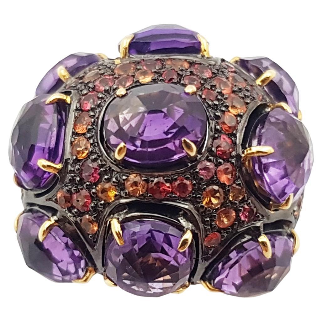 Amethyst with Orange Sapphire Ring set in Silver Settings

Width:  2.5 cm 
Length: 2.5 cm
Ring Size: 53
Total Weight: 19.38 grams

*Please note that the silver setting is plated with gold and rhodium to promote shine and help prevent oxidation. 