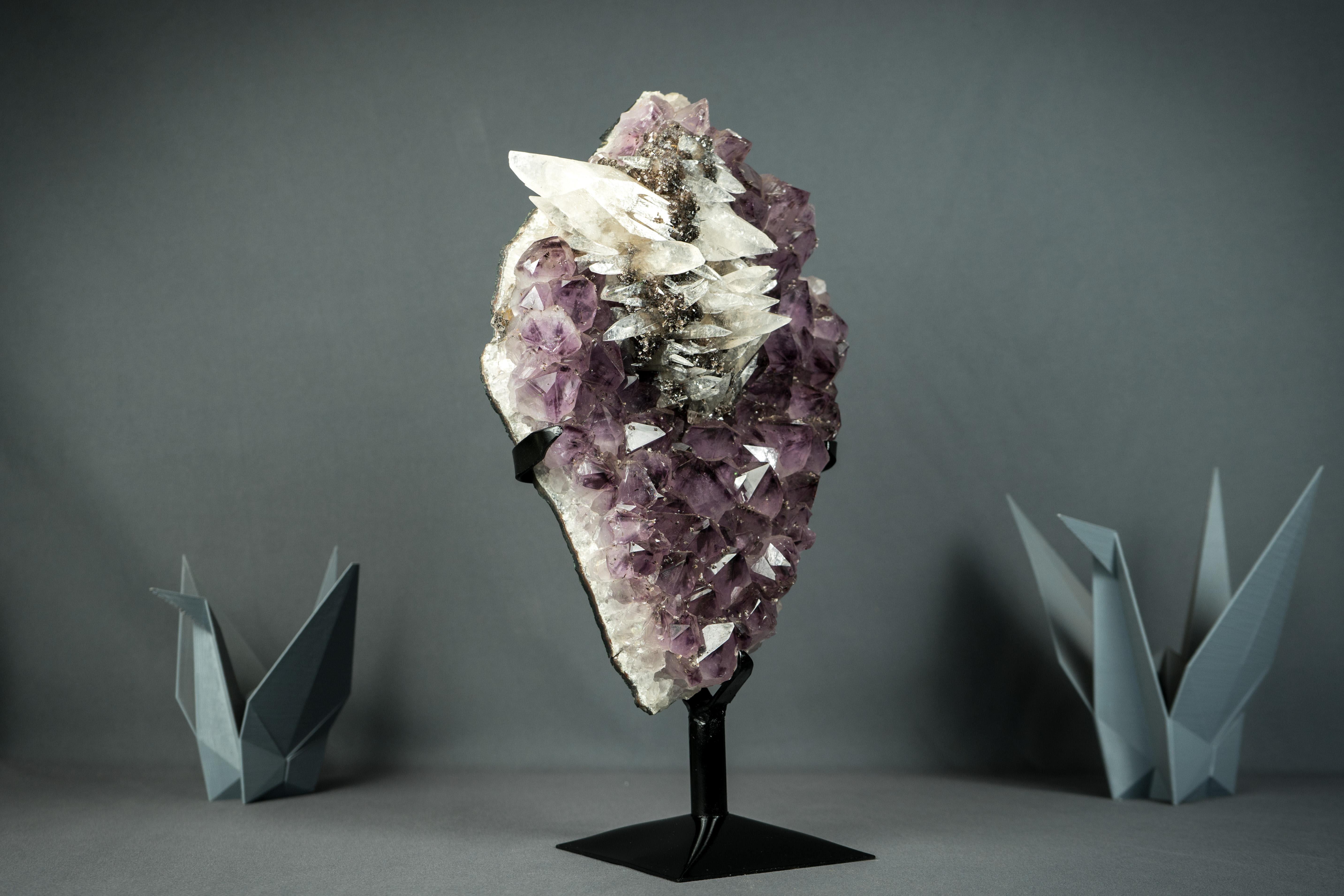 Cluster di ametista con raro cluster di calcite scalenoedrica

▫️ Descrizione
Formata raramente e caratterizzata da elementi ed estetica bellissimi, questo cluster di calcite su ametista è un reperto raro e pronto per essere aggiunto alla tua